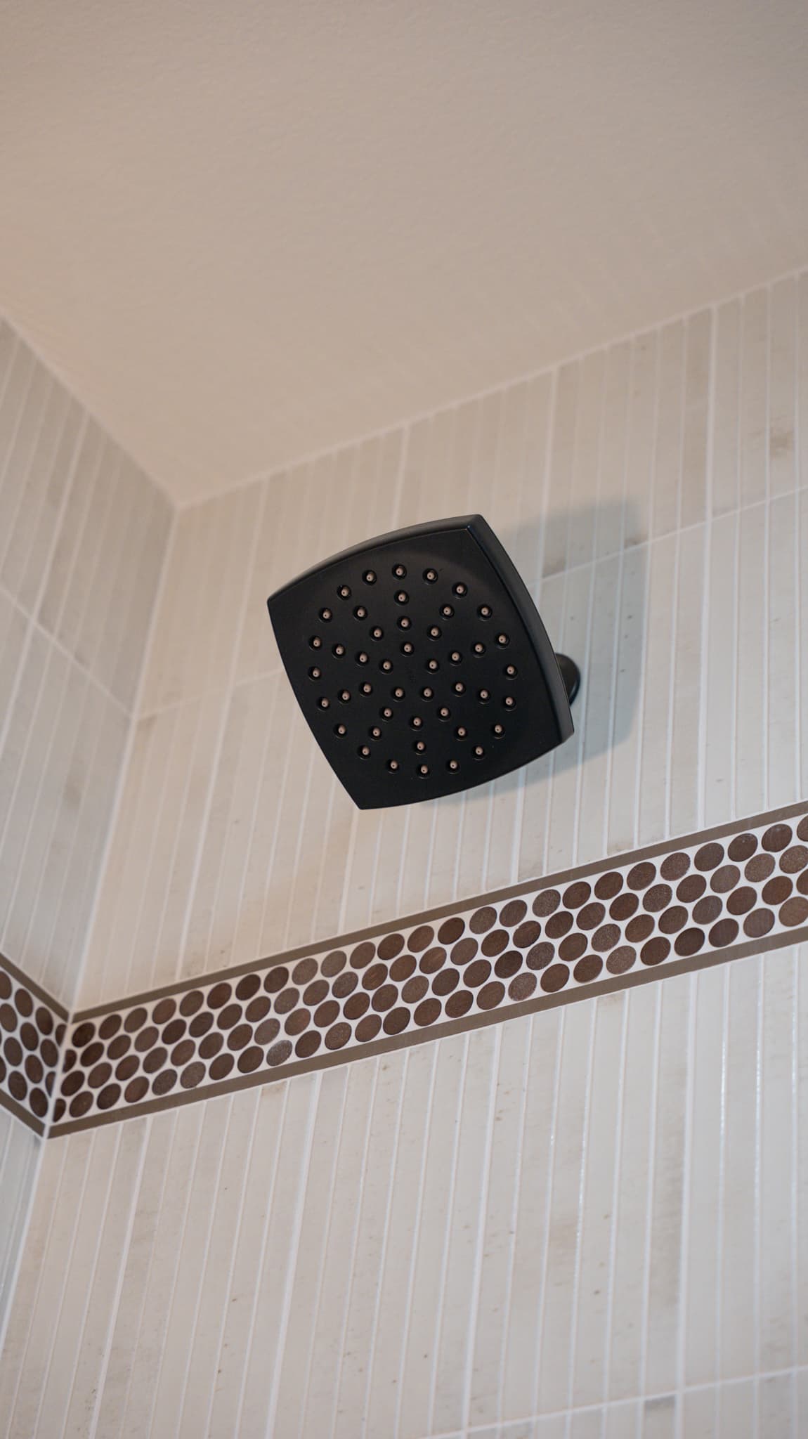 Bathroom Remodel in Folsom — tiled shower surround, mosaic backsplash, walk-in shower, rain shower head, natural-stone tile flooring