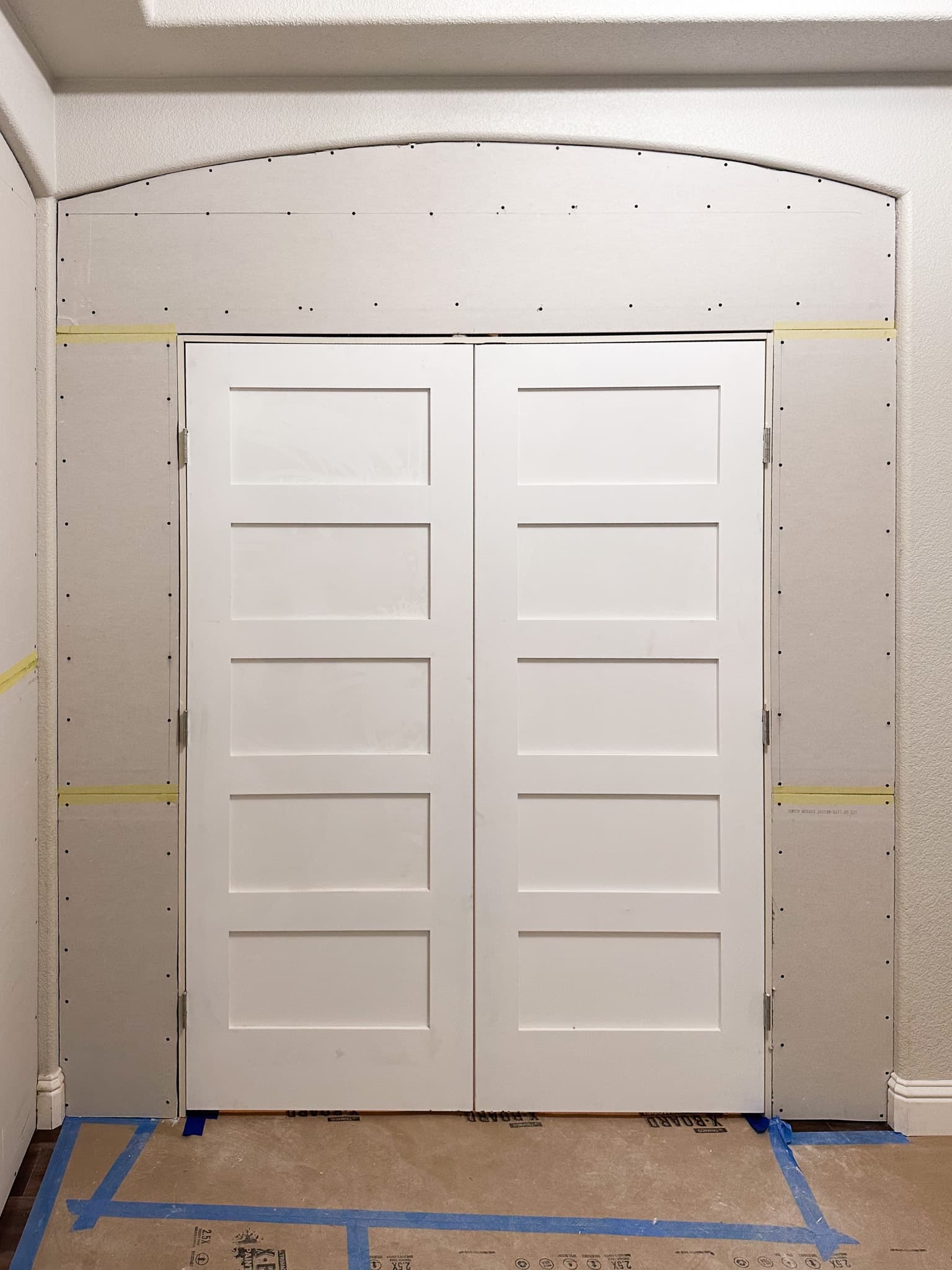 House Renovation in Citrus Heights — framing stage, barn-door entry, crown moulding, hardwood flooring, wainscoting