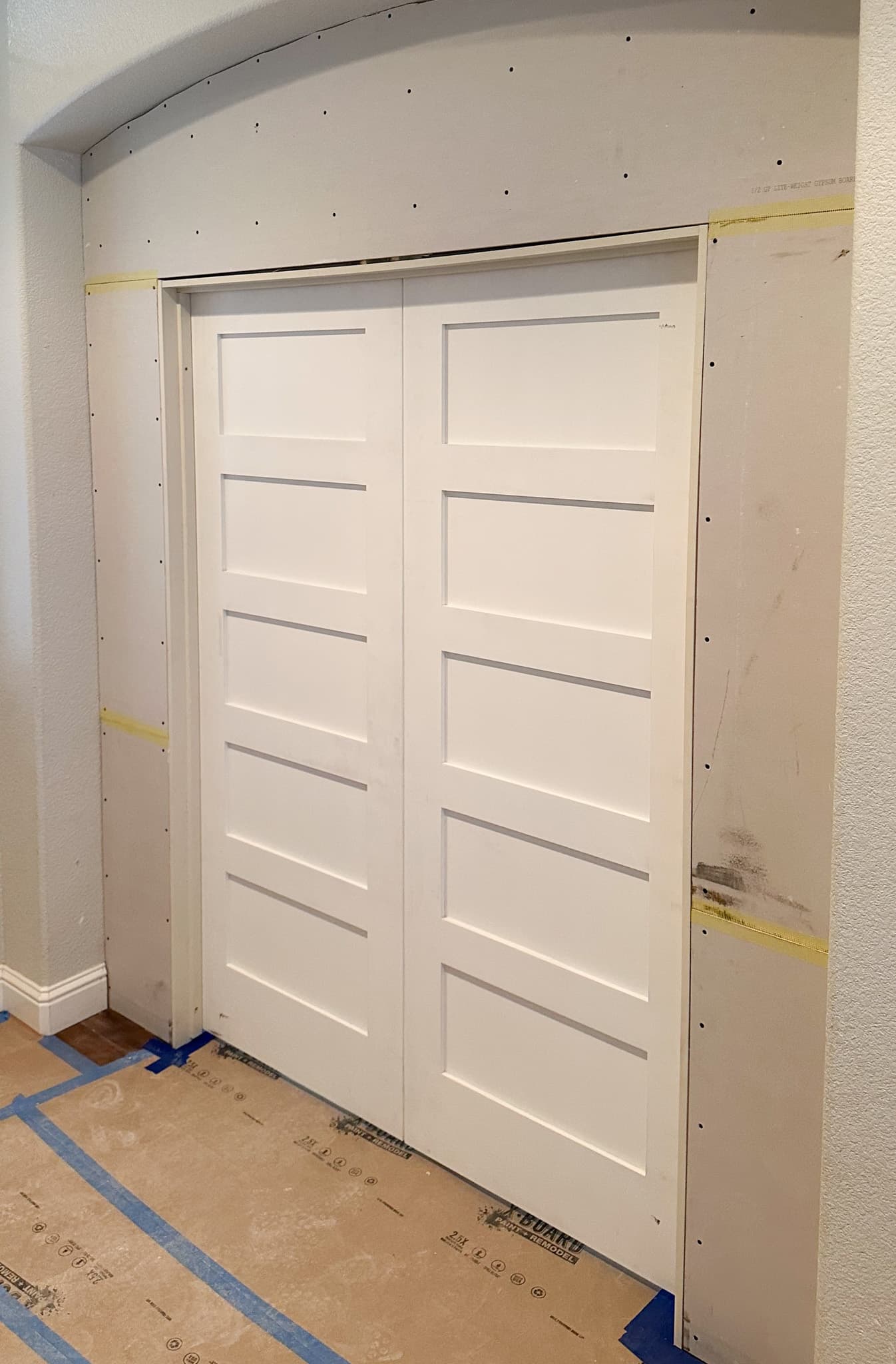 House Renovation in Citrus Heights — framing stage, barn-door entry, hardwood flooring, wainscoting, crown moulding