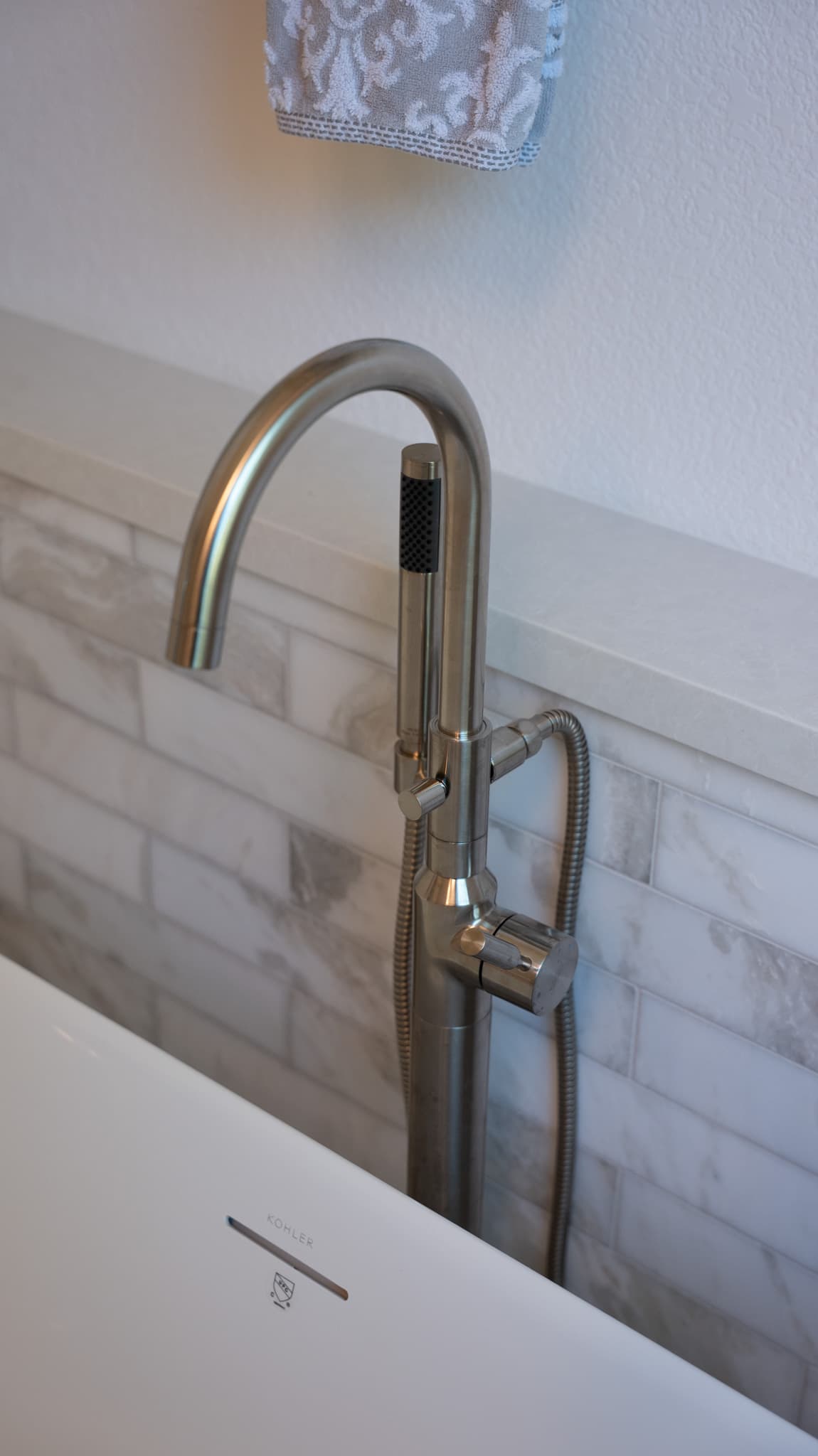 Bathroom Remodel in Sacramento — freestanding tub, soaking tub, handheld shower, natural-stone backsplash, subway tile backsplash