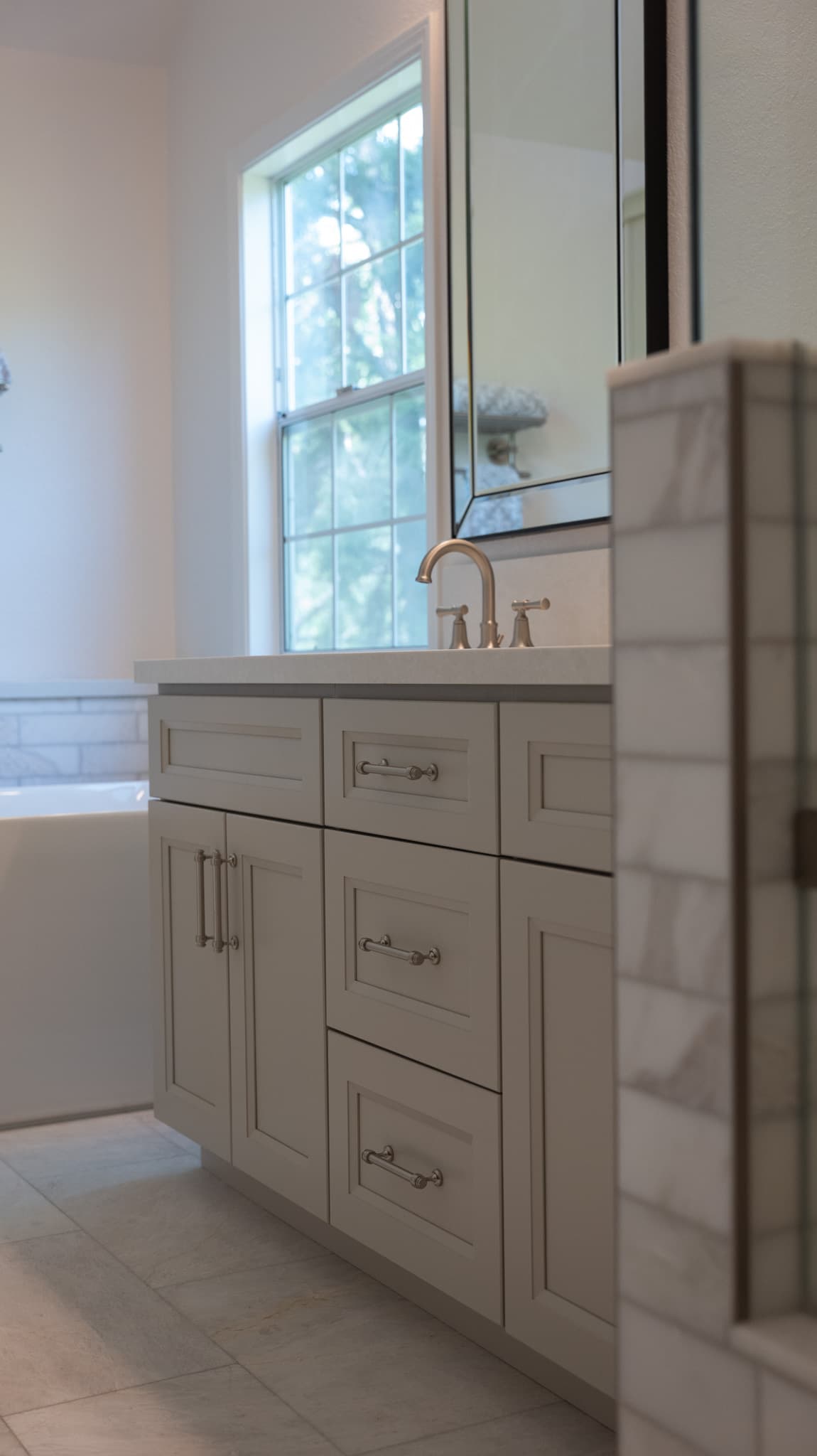 Bathroom Remodel in Sacramento — shaker cabinets, single vanity, undermount sink, framed mirror, porcelain tile flooring
