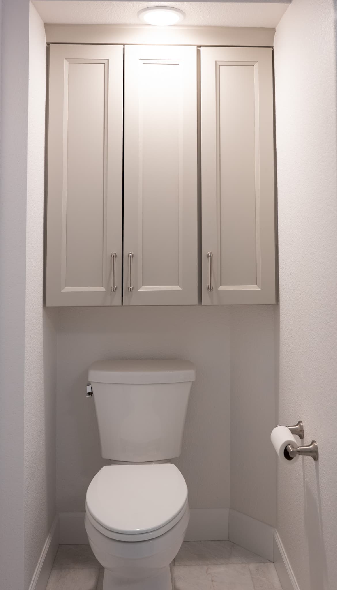 Bathroom Remodel in Sacramento — shaker cabinets, linen tower, recessed lighting, porcelain tile flooring, built-in shelving