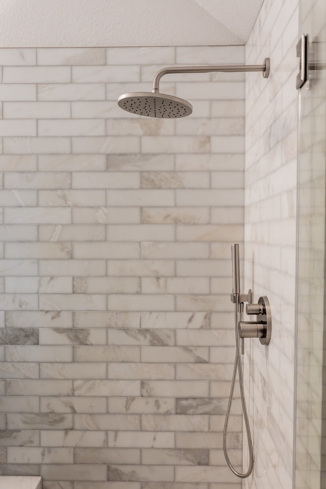 Bathroom Remodel in Sacramento — walk-in shower, rain shower head, handheld shower, tiled shower surround, natural-stone backsplash