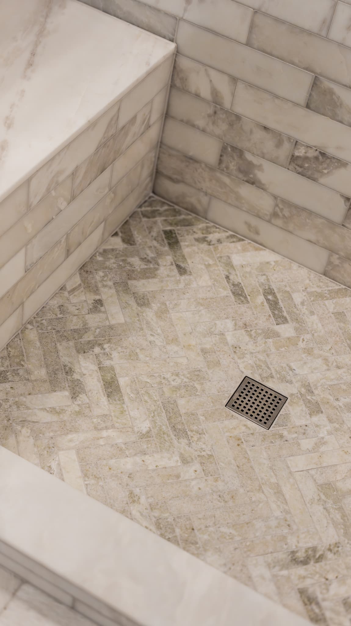 Bathroom Remodel in Sacramento — walk-in shower, tiled shower surround, shower bench, natural-stone tile flooring, marble tile flooring