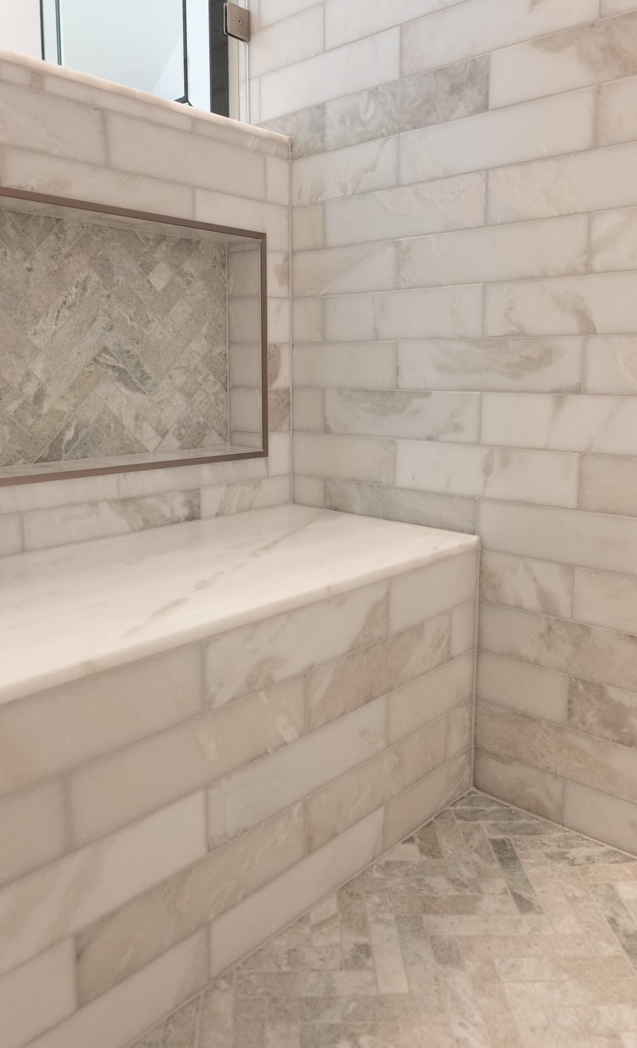 Bathroom Remodel in Sacramento — walk-in shower, tiled shower surround, shower bench, natural-stone tile flooring, frameless glass shower