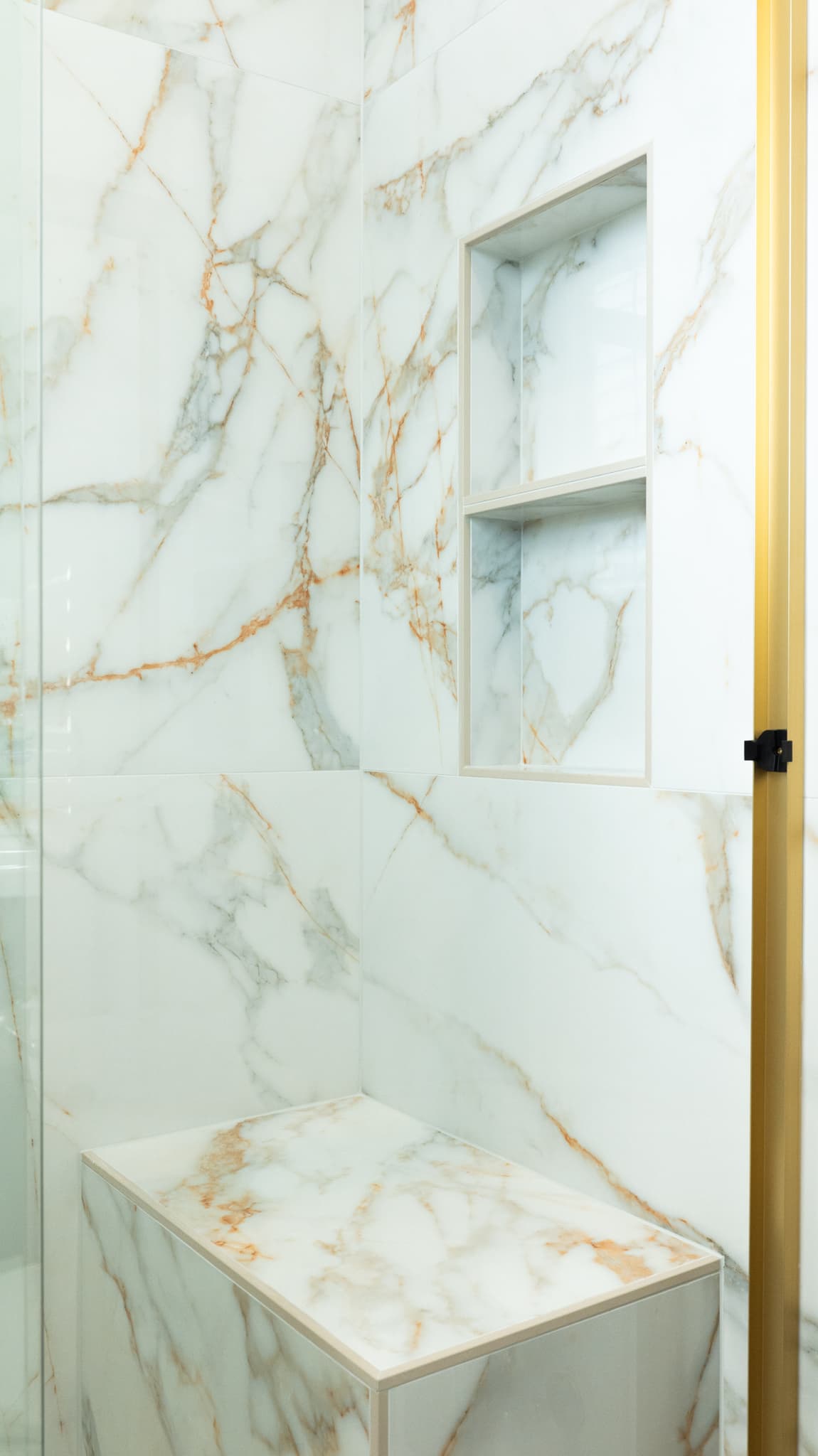 Bathroom Remodel in El Dorado Hills — walk-in shower, frameless glass shower, tiled shower surround, shower bench, marble tile flooring