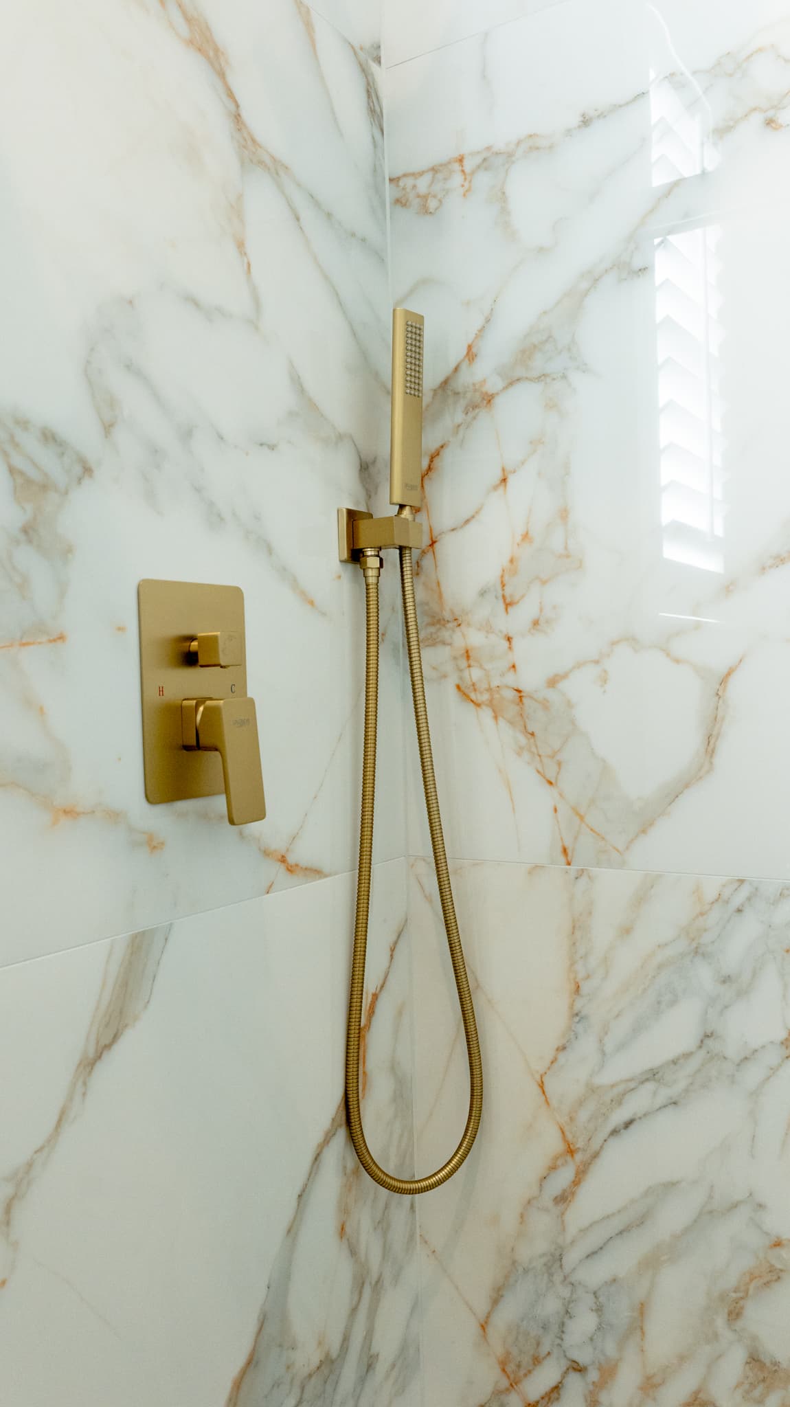 Bathroom Remodel in El Dorado Hills — walk-in shower, tiled shower surround, marble tile flooring, handheld shower