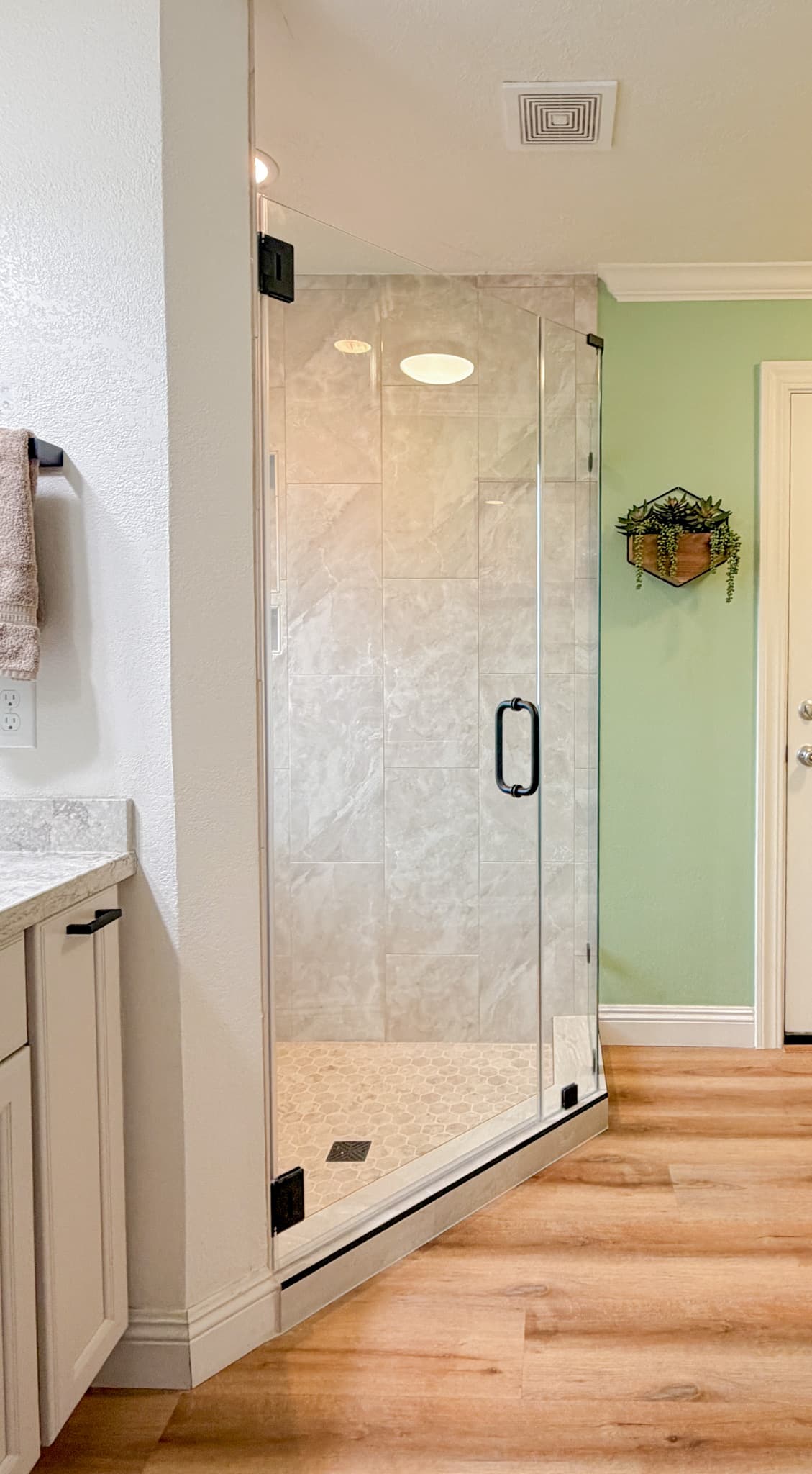 Bathroom Remodel in Sacramento — frameless glass shower, tiled shower surround, walk-in shower, luxury vinyl plank, shaker cabinets