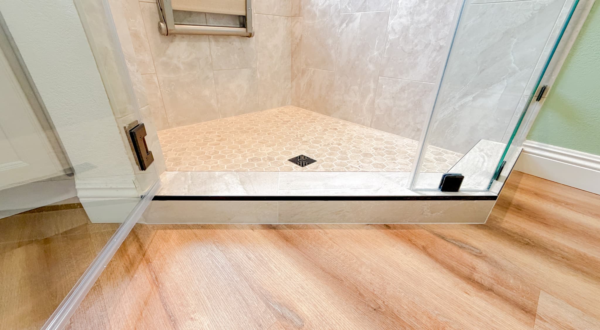 Bathroom Remodel in Sacramento — walk-in shower, frameless glass shower, tiled shower surround, mosaic backsplash, luxury vinyl plank