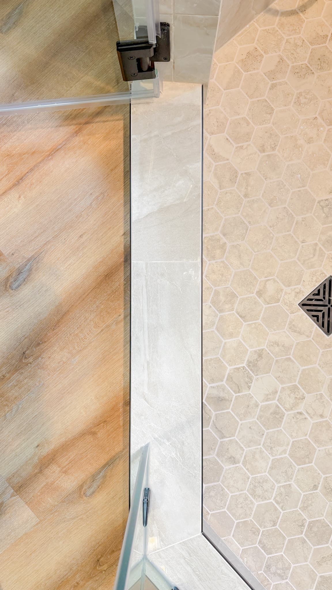 Bathroom Remodel in Sacramento — frameless glass shower, walk-in shower, tiled shower surround, mosaic backsplash, luxury vinyl plank