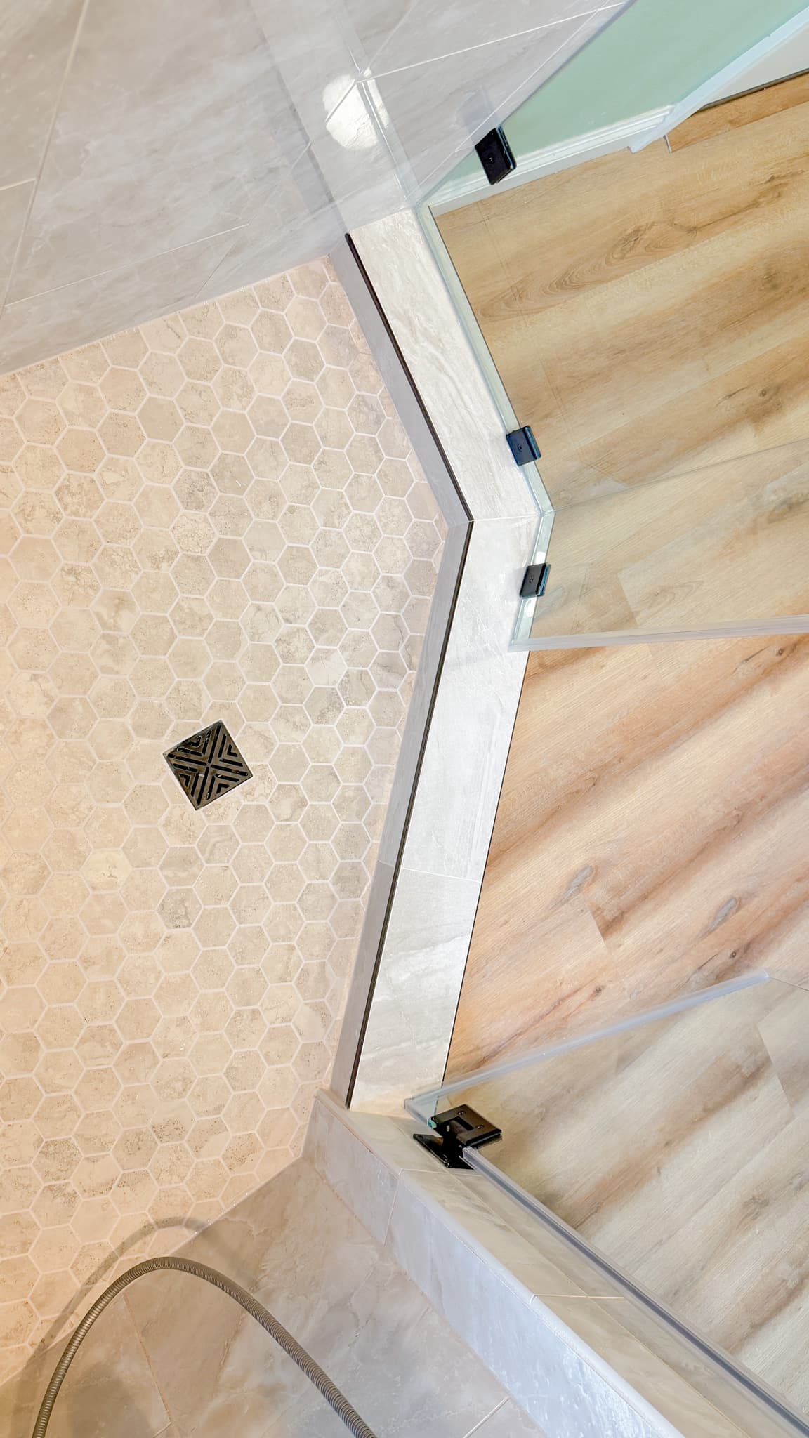 Bathroom Remodel in Sacramento — frameless glass shower, walk-in shower, tiled shower surround, mosaic backsplash, luxury vinyl plank