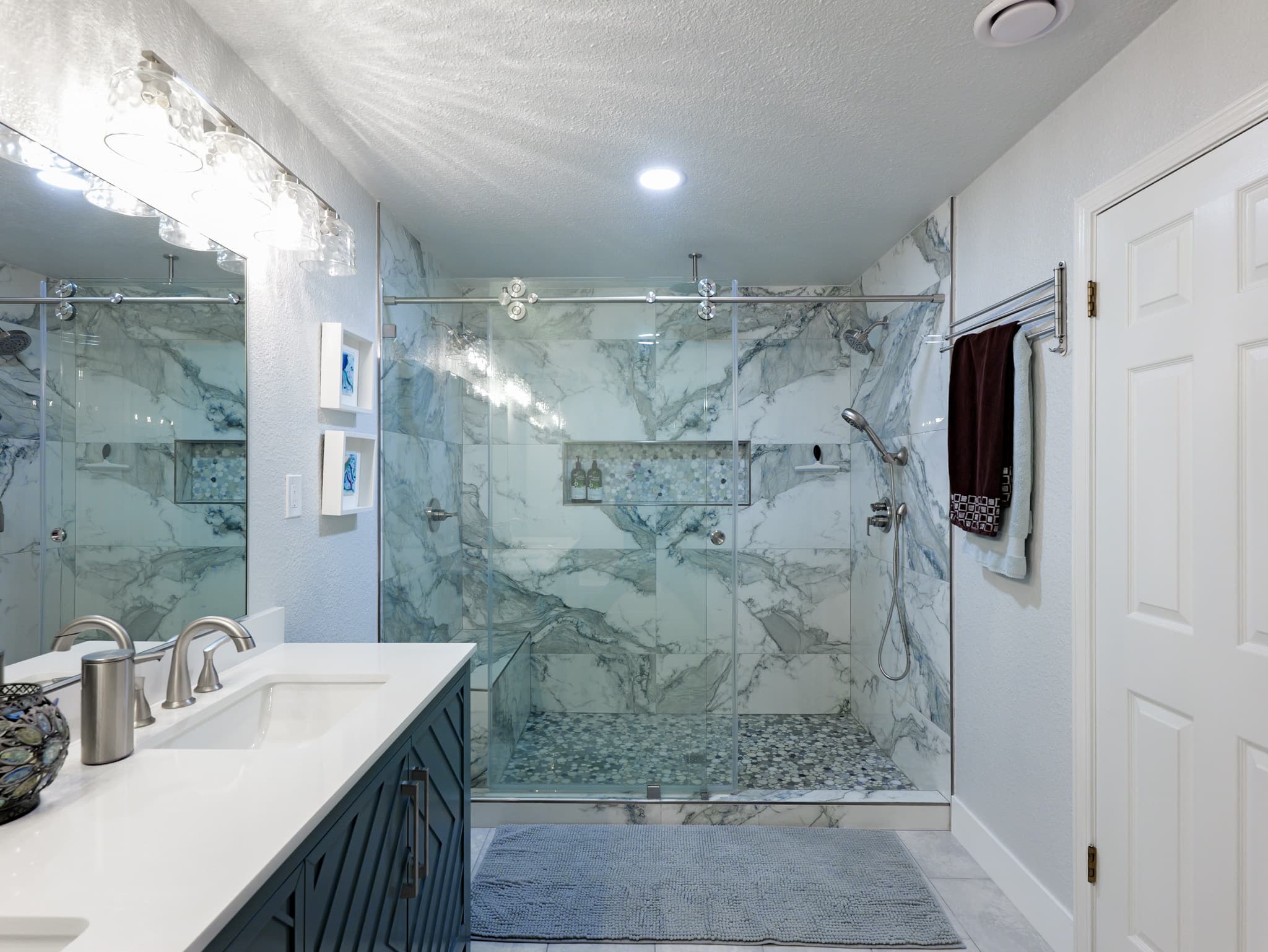 Bathroom Remodel in Sacramento — frameless glass shower, marble tile flooring, tiled shower surround, handheld shower, double vanity