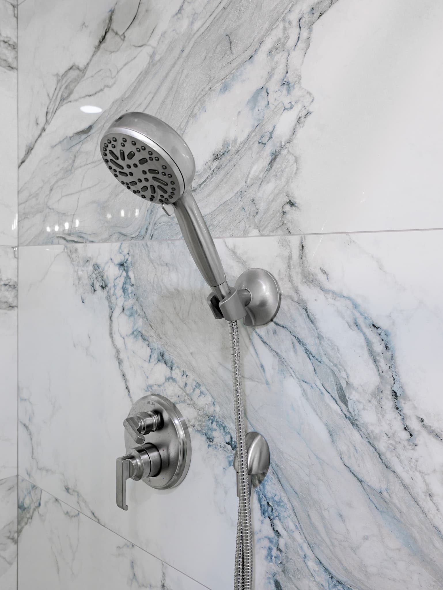 Bathroom Remodel in Sacramento — tiled shower surround, handheld shower, walk-in shower, marble tile flooring, recessed lighting