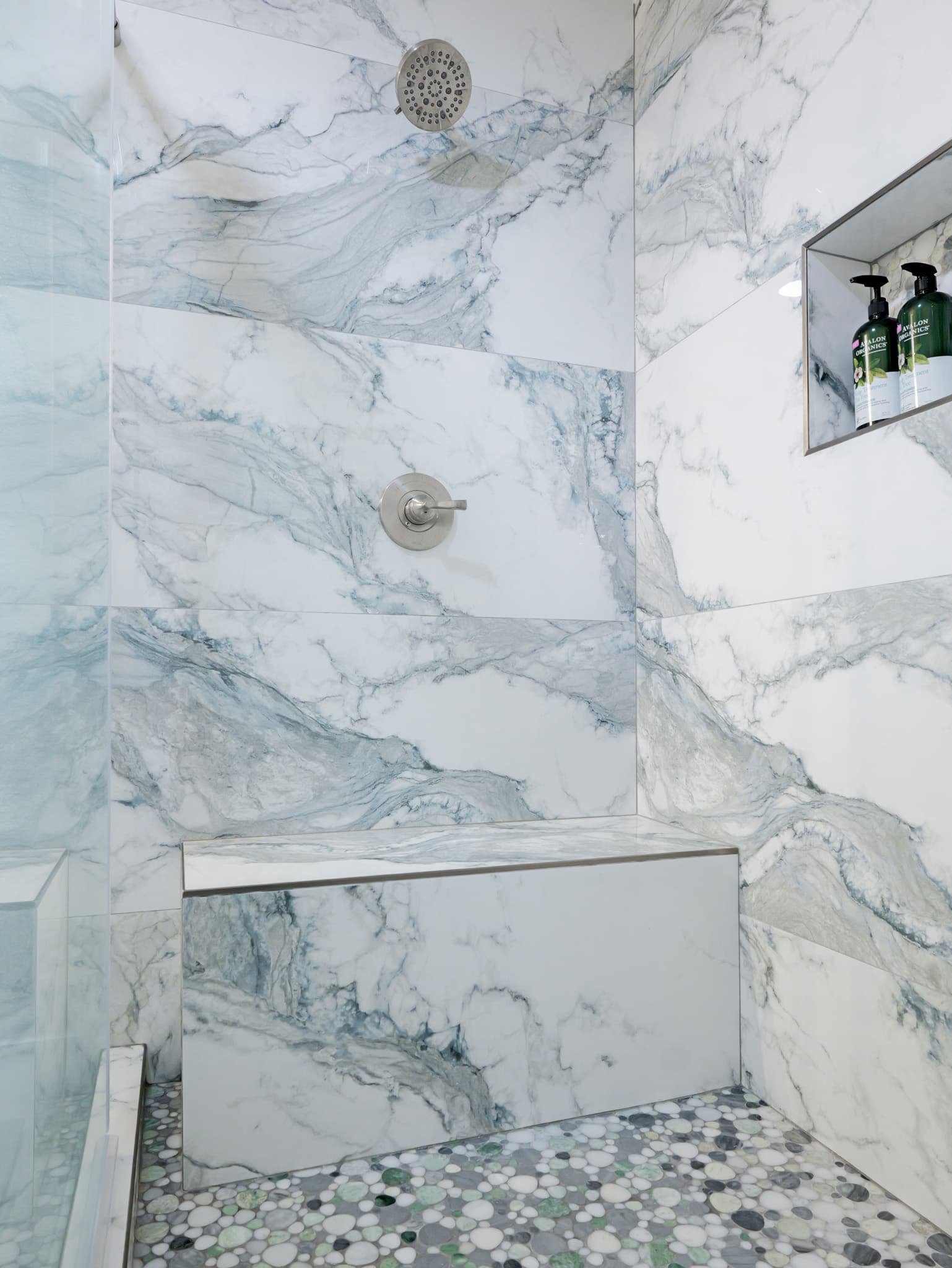 Bathroom Remodel in Sacramento — walk-in shower, marble tile flooring, tiled shower surround, shower bench, rain shower head