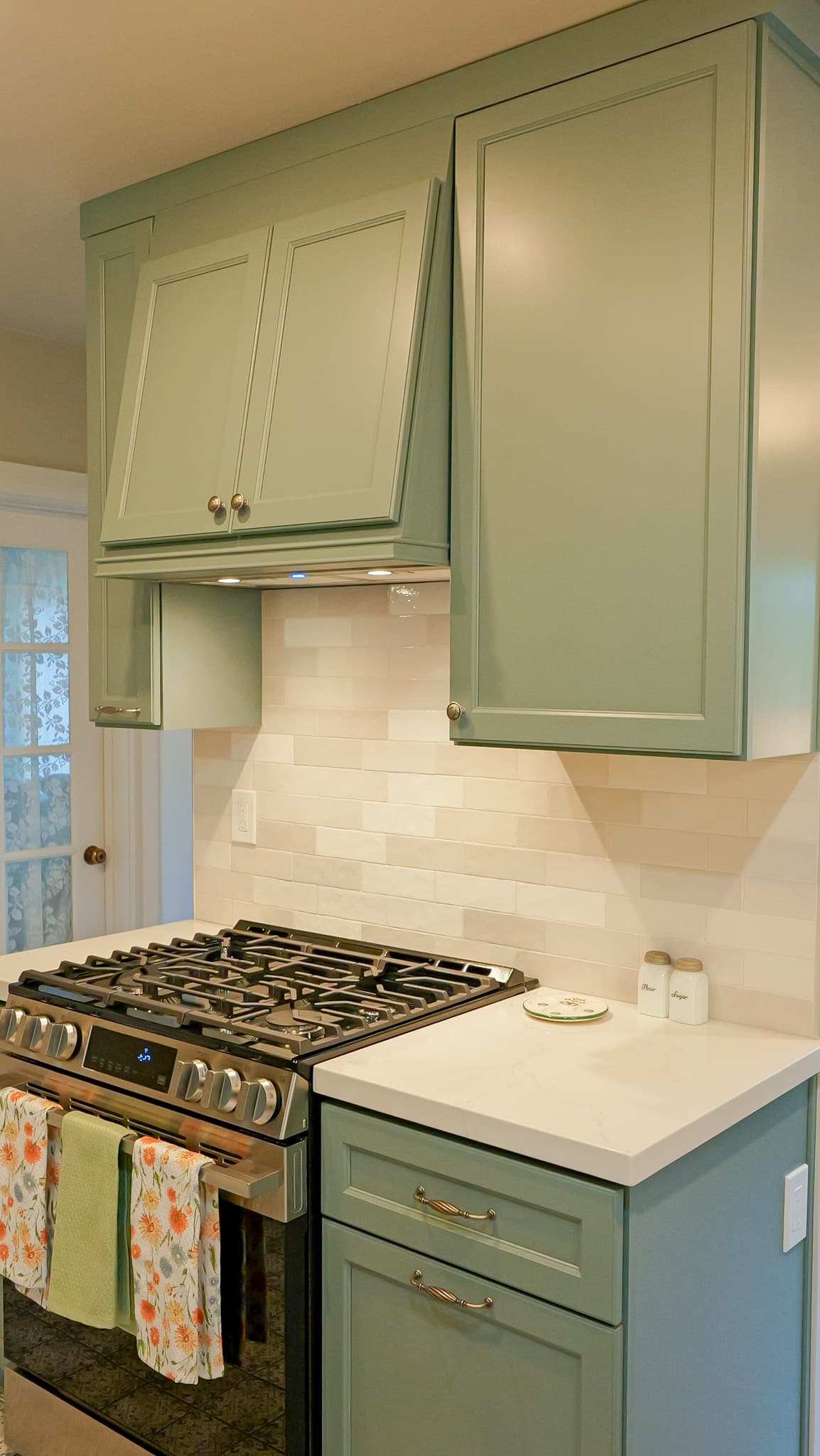 Kitchen Remodel in Sacramento — raised-panel cabinets, range hood, subway tile backsplash, professional gas range, quartz countertop