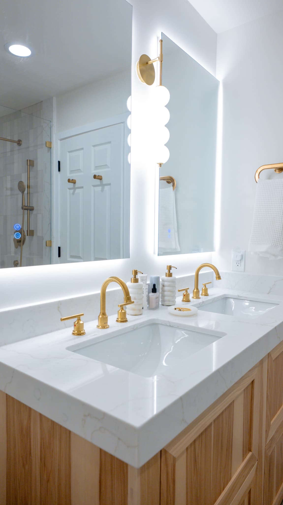 Kitchen Remodel in Sacramento — double vanity, lighted mirror, undermount sink, quartz countertop, frameless glass shower