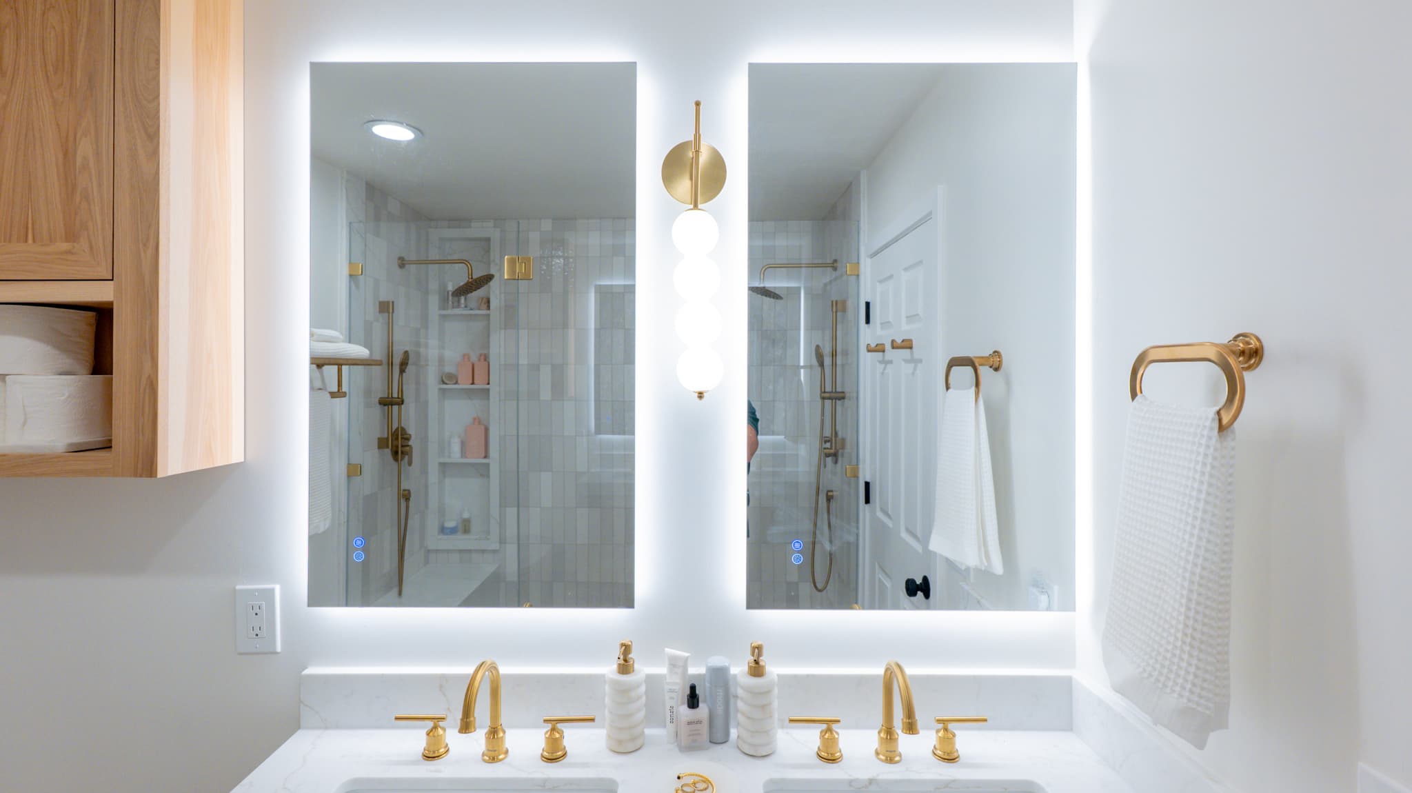 Kitchen Remodel in Sacramento — double vanity, lighted mirror, frameless glass shower, tiled shower surround, handheld shower