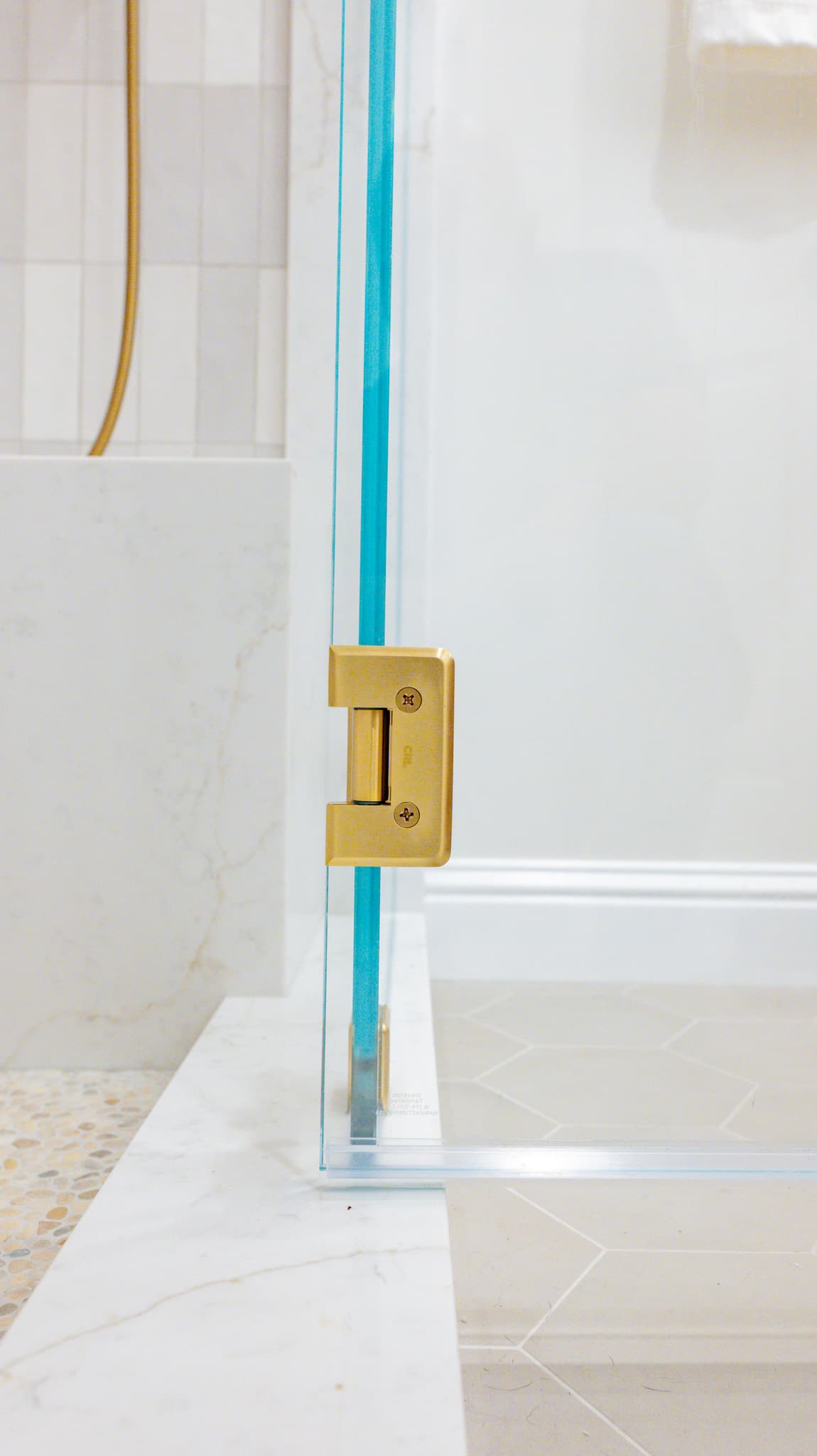 Kitchen Remodel in Sacramento — frameless glass shower, tiled shower surround, natural-stone tile flooring, handheld shower, walk-in shower