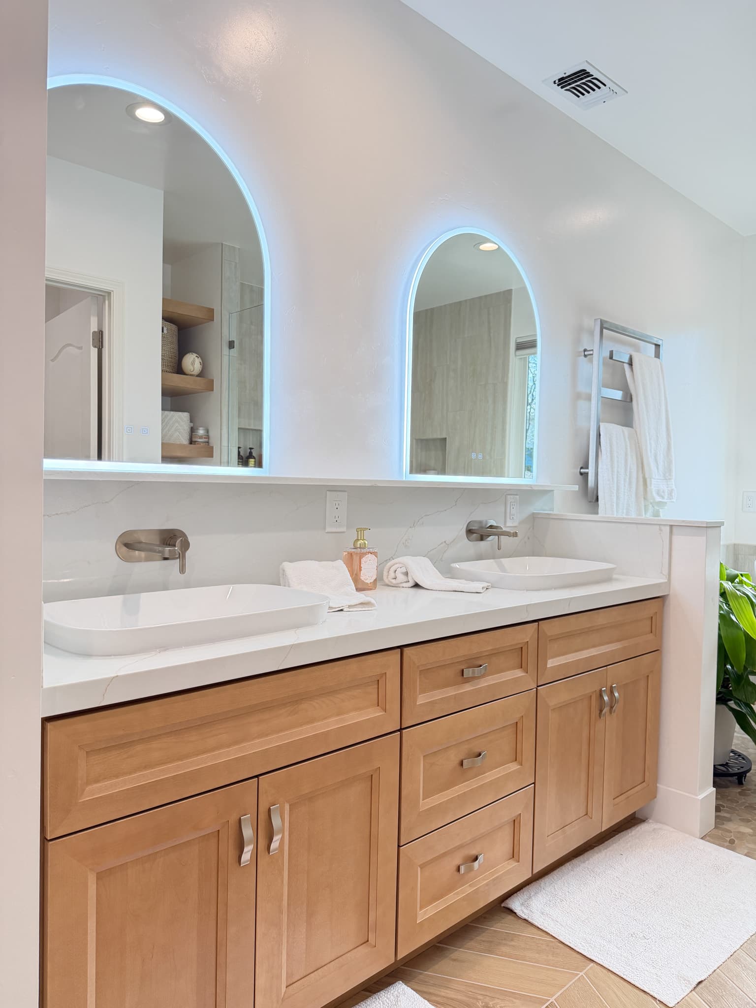 Bathroom Remodel in Carmichael — double vanity, vessel sink, lighted mirror, quartz countertop, raised-panel cabinets