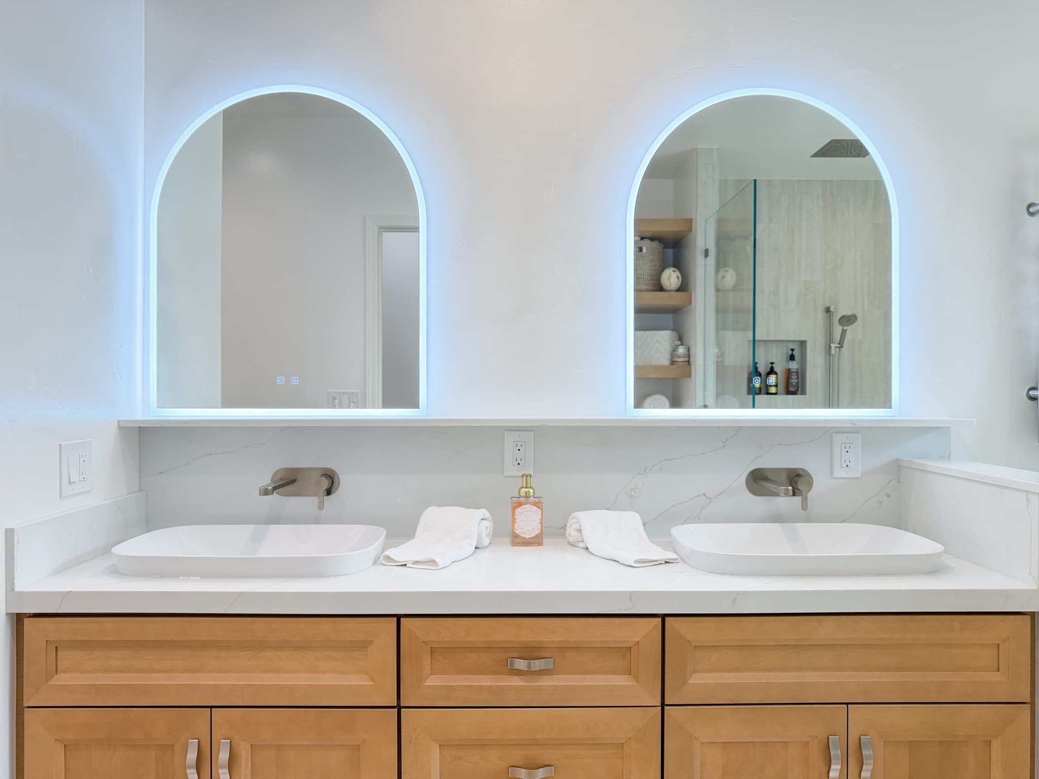 Bathroom Remodel in Carmichael — double vanity, vessel sink, lighted mirror, quartz countertop, frameless glass shower