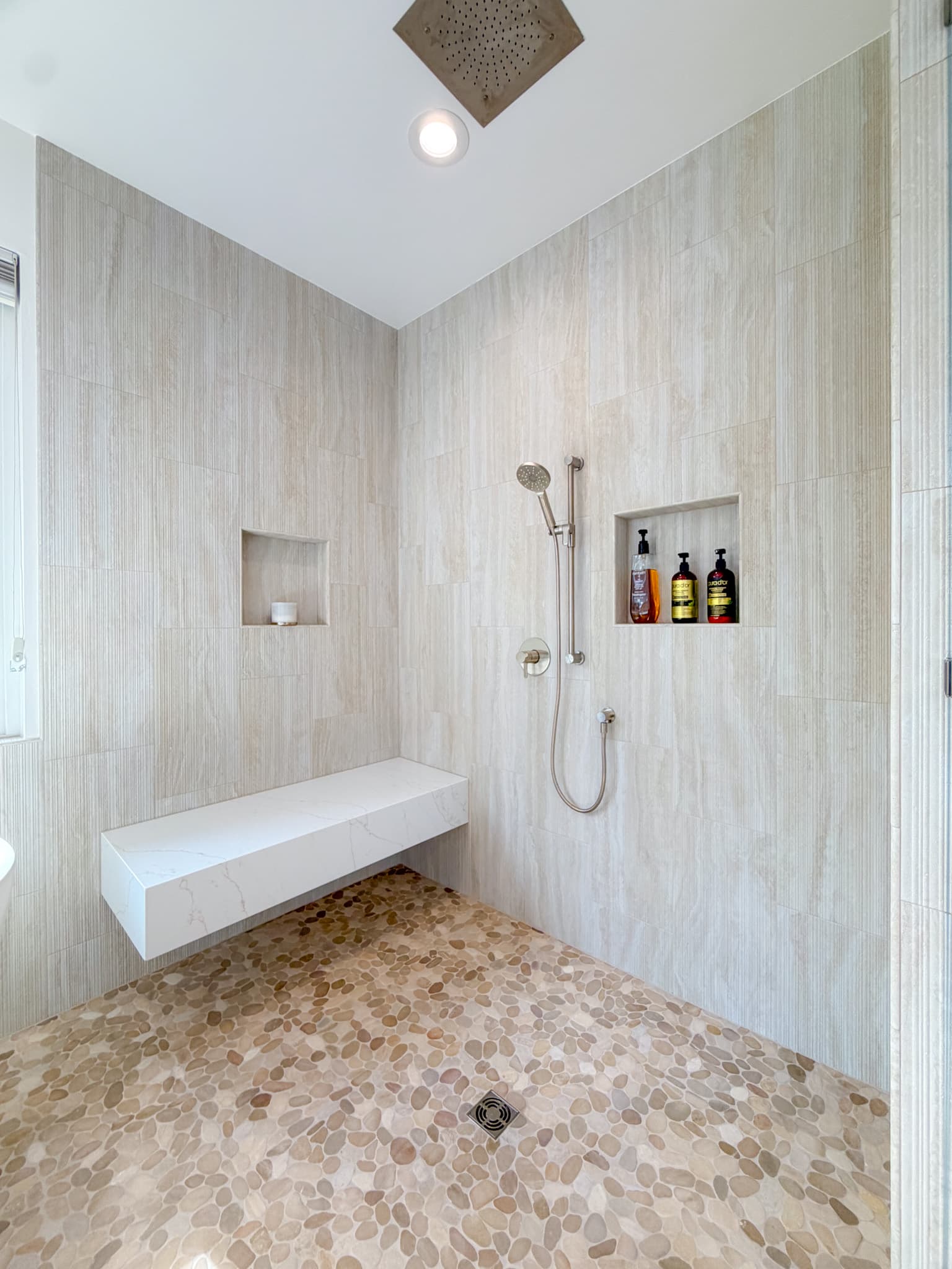 Bathroom Remodel in Carmichael — walk-in shower, tiled shower surround, rain shower head, handheld shower, shower bench