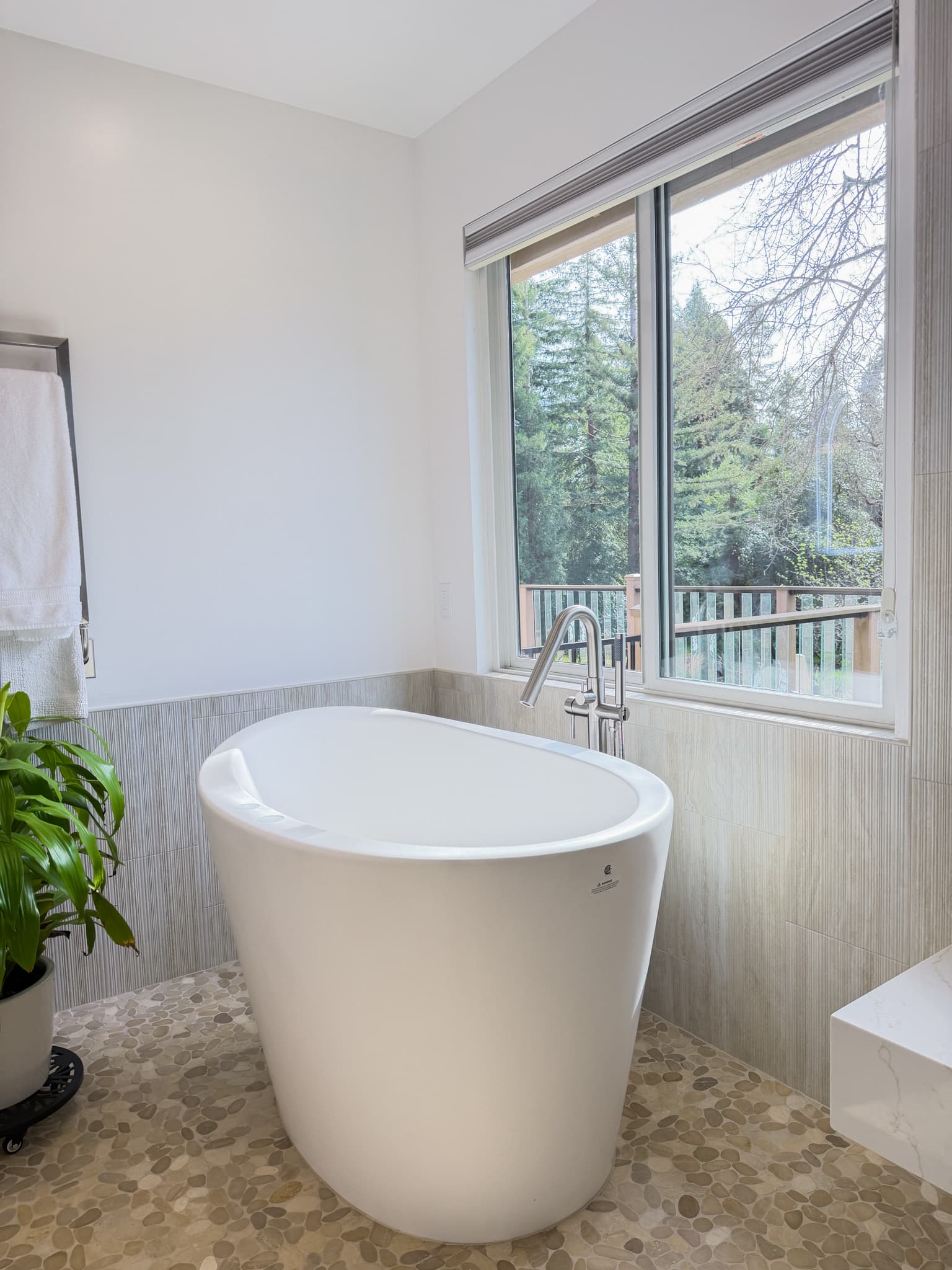 Bathroom Remodel in Carmichael — freestanding tub, soaking tub, natural-stone tile flooring, mosaic backsplash, quartz countertop