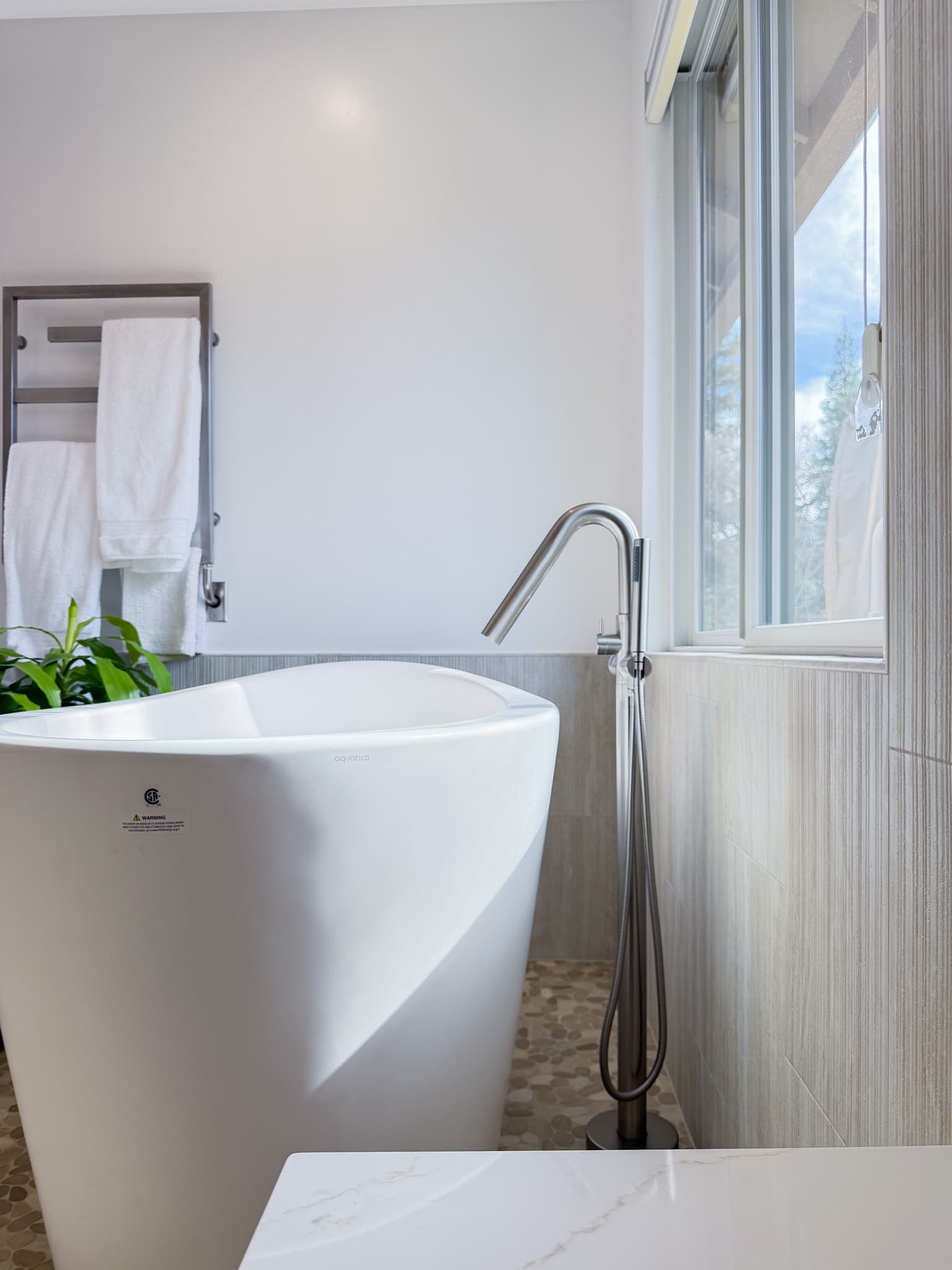 Bathroom Remodel in Carmichael — freestanding tub, handheld shower, marble countertop, tiled shower surround, natural-stone tile flooring