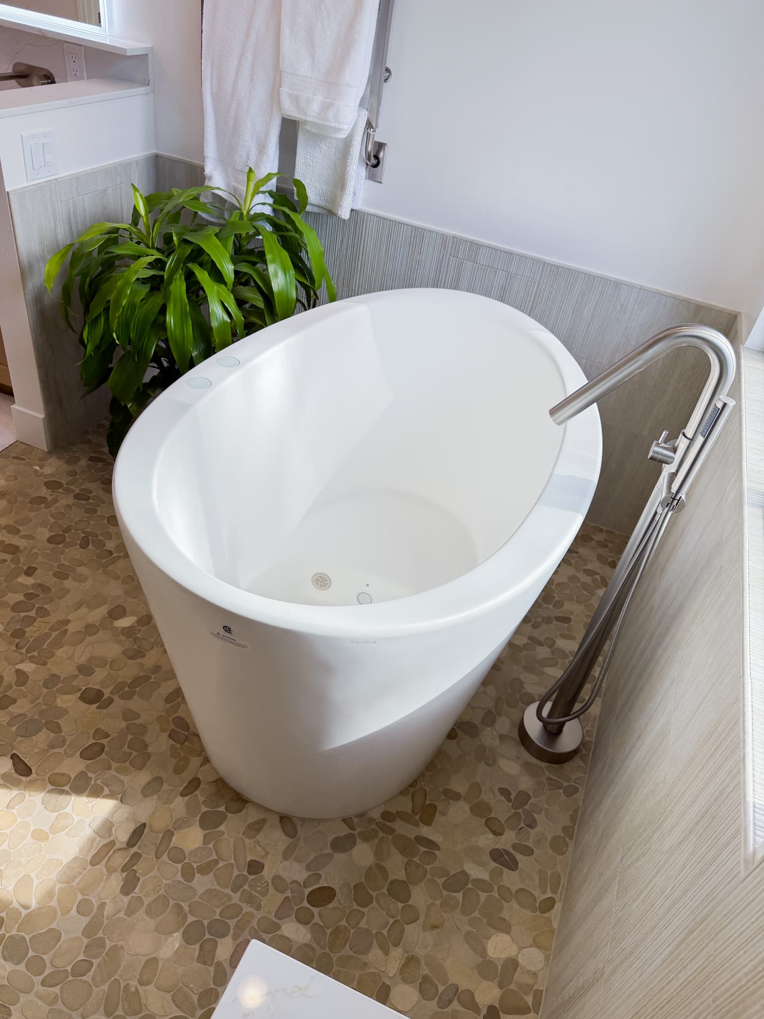 Bathroom Remodel in Carmichael — soaking tub, freestanding tub, natural-stone tile flooring, handheld shower, walk-in bathtub