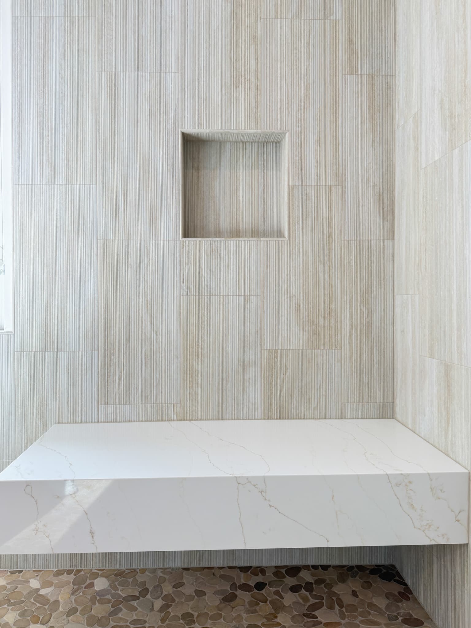 Bathroom Remodel in Carmichael — walk-in shower, tiled shower surround, shower bench, mosaic backsplash, marble countertop