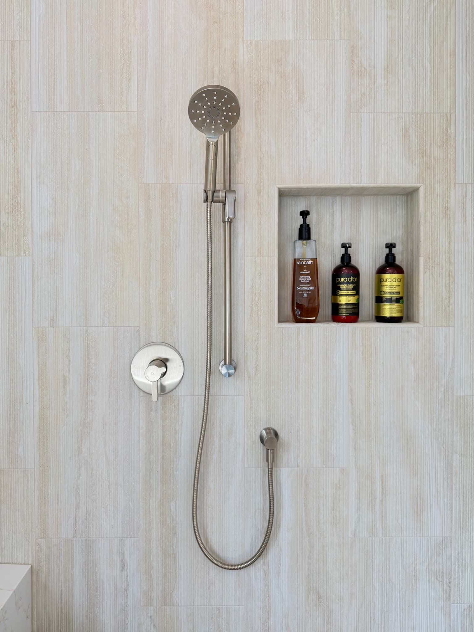 Bathroom Remodel in Carmichael — tiled shower surround, handheld shower, walk-in shower, built-in shelving, shower bench