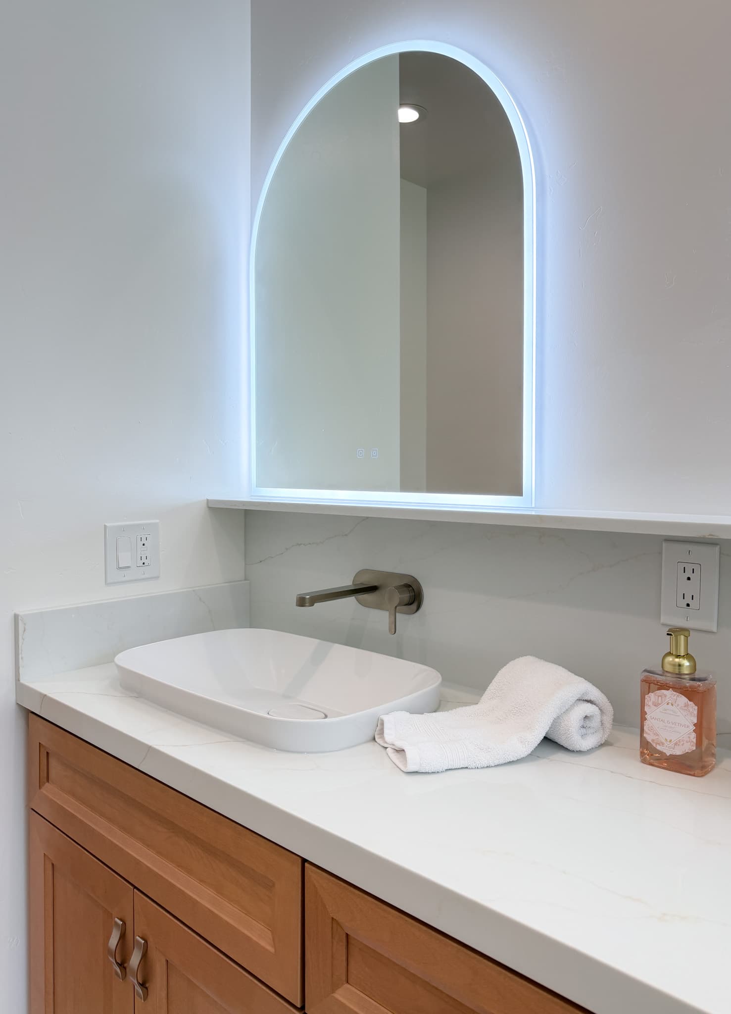 Bathroom Remodel in Carmichael — lighted mirror, vessel sink, quartz countertop, single vanity, raised-panel cabinets