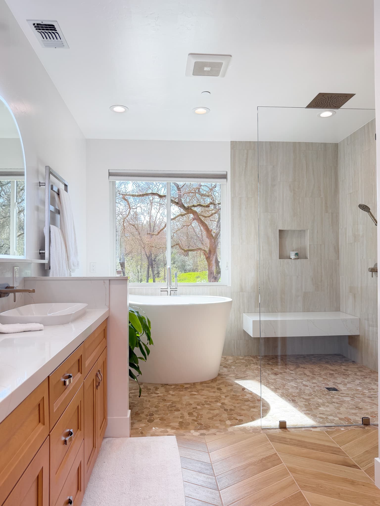 Bathroom Remodel in Carmichael — freestanding tub, frameless glass shower, rain shower head, shower bench, recessed lighting