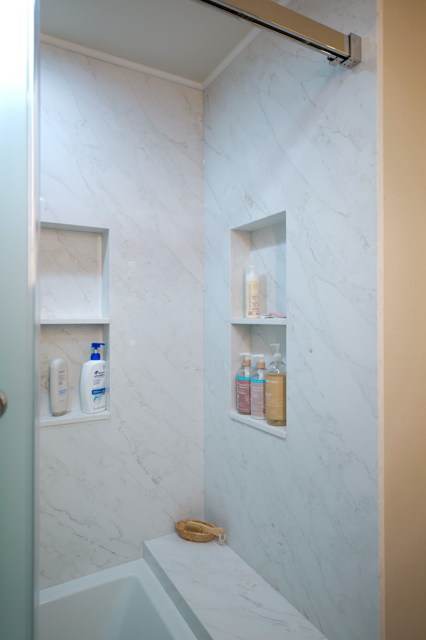 House Renovation in Sacramento — walk-in shower, frameless glass shower, tiled shower surround, shower bench, built-in shelving