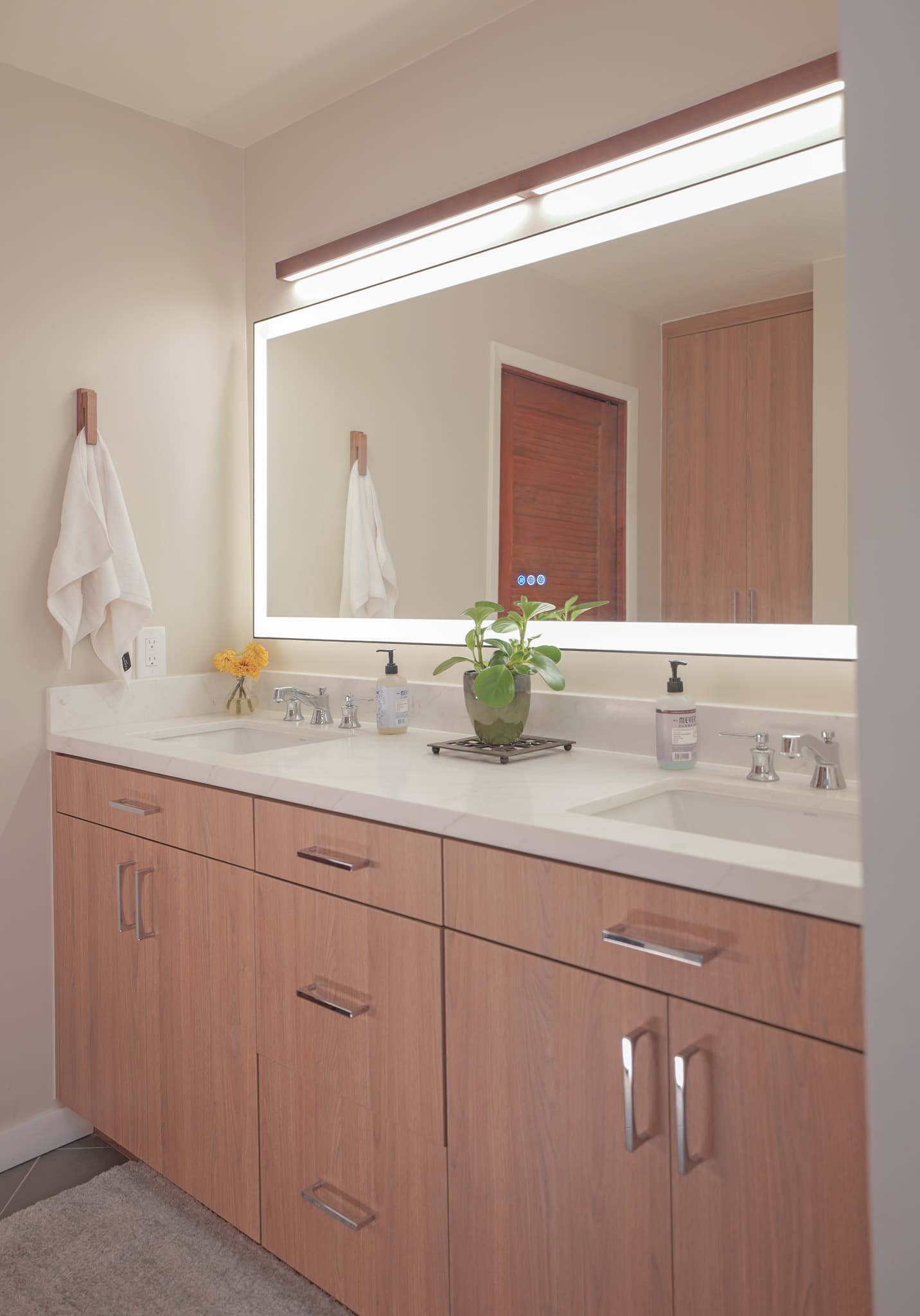 House Renovation in Sacramento — double vanity, lighted mirror, undermount sink, quartz countertop, custom cabinetry