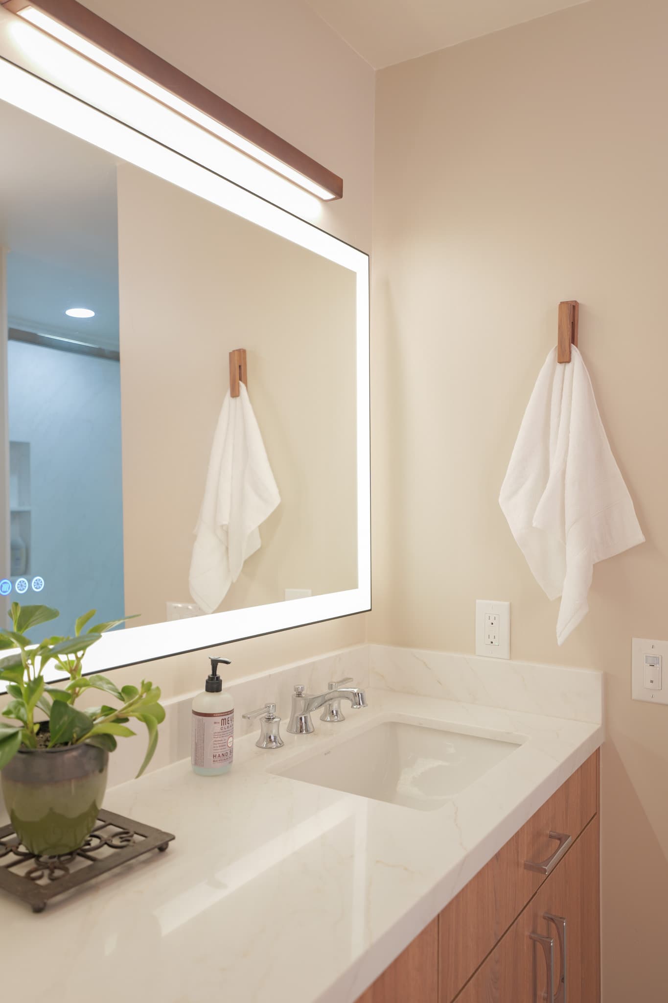 House Renovation in Sacramento — lighted mirror, undermount sink, single vanity, quartz countertop, floating vanity