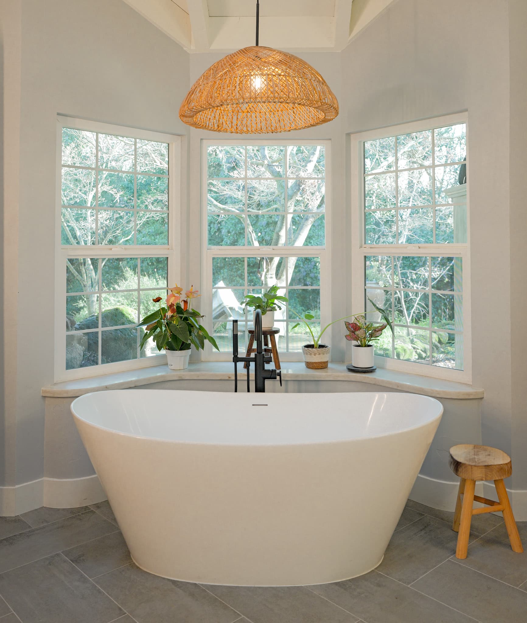 House Renovation in Sacramento — freestanding tub, soaking tub, pendant lighting, porcelain tile flooring, vaulted ceiling