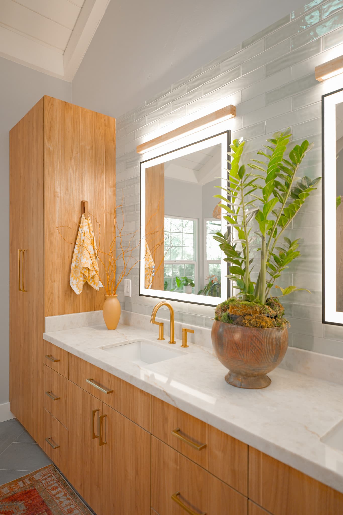 House Renovation in Sacramento — floating vanity, lighted mirror, undermount sink, subway tile backsplash, linen tower