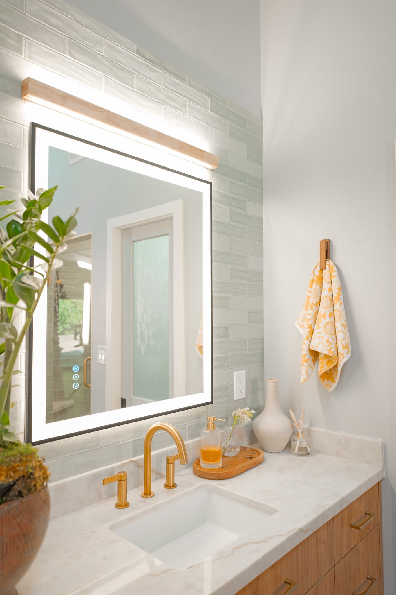 House Renovation in Sacramento — lighted mirror, undermount sink, marble countertop, subway tile backsplash, single vanity