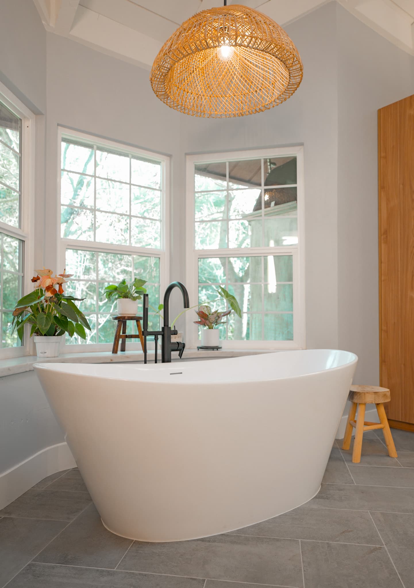 House Renovation in Sacramento — freestanding tub, soaking tub, pendant lighting, natural-stone tile flooring, vaulted ceiling