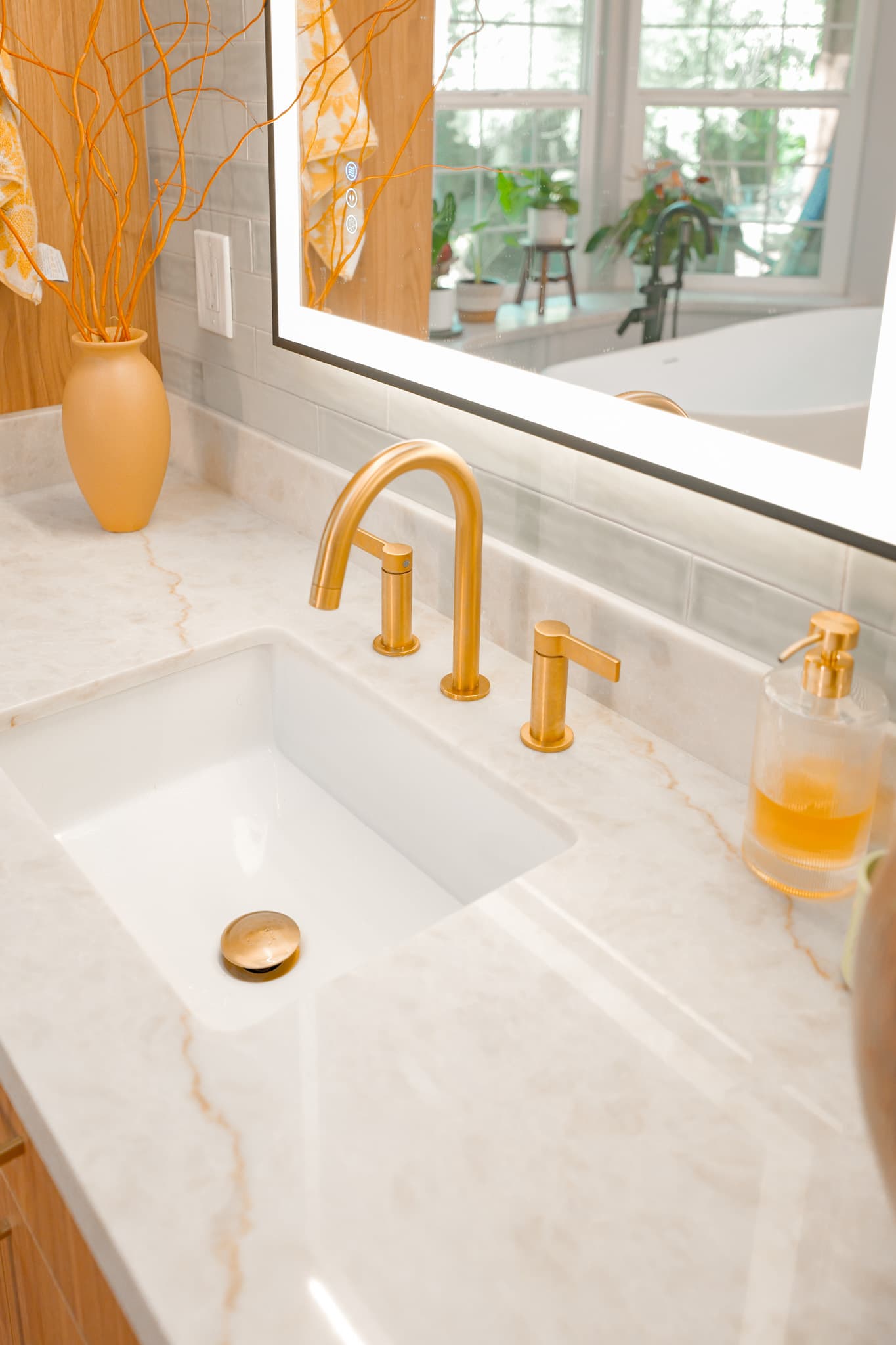 House Renovation in Sacramento — undermount sink, marble countertop, lighted mirror, subway tile backsplash, freestanding tub