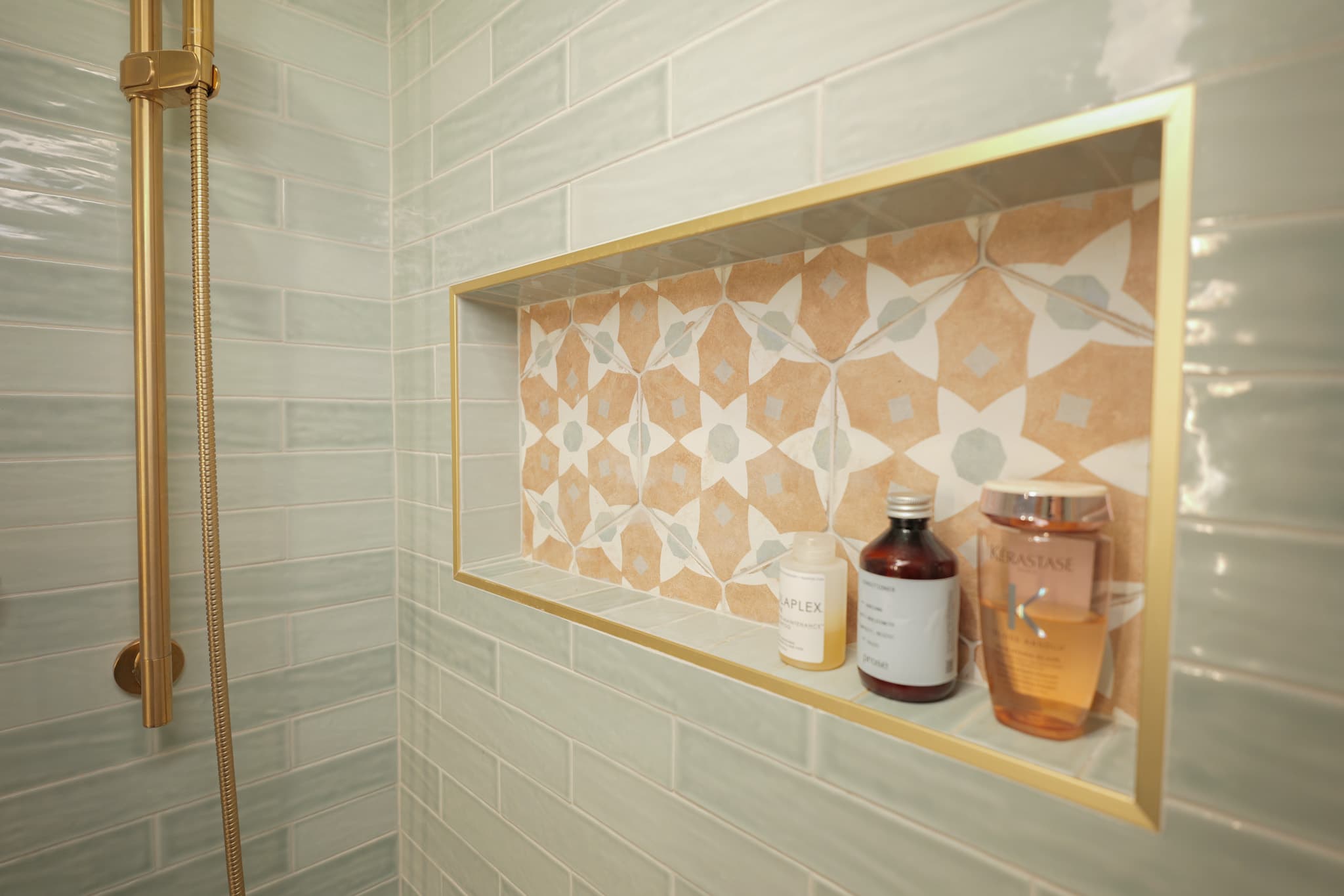 House Renovation in Sacramento — tiled shower surround, handheld shower, mosaic backsplash, walk-in shower, built-in shelving