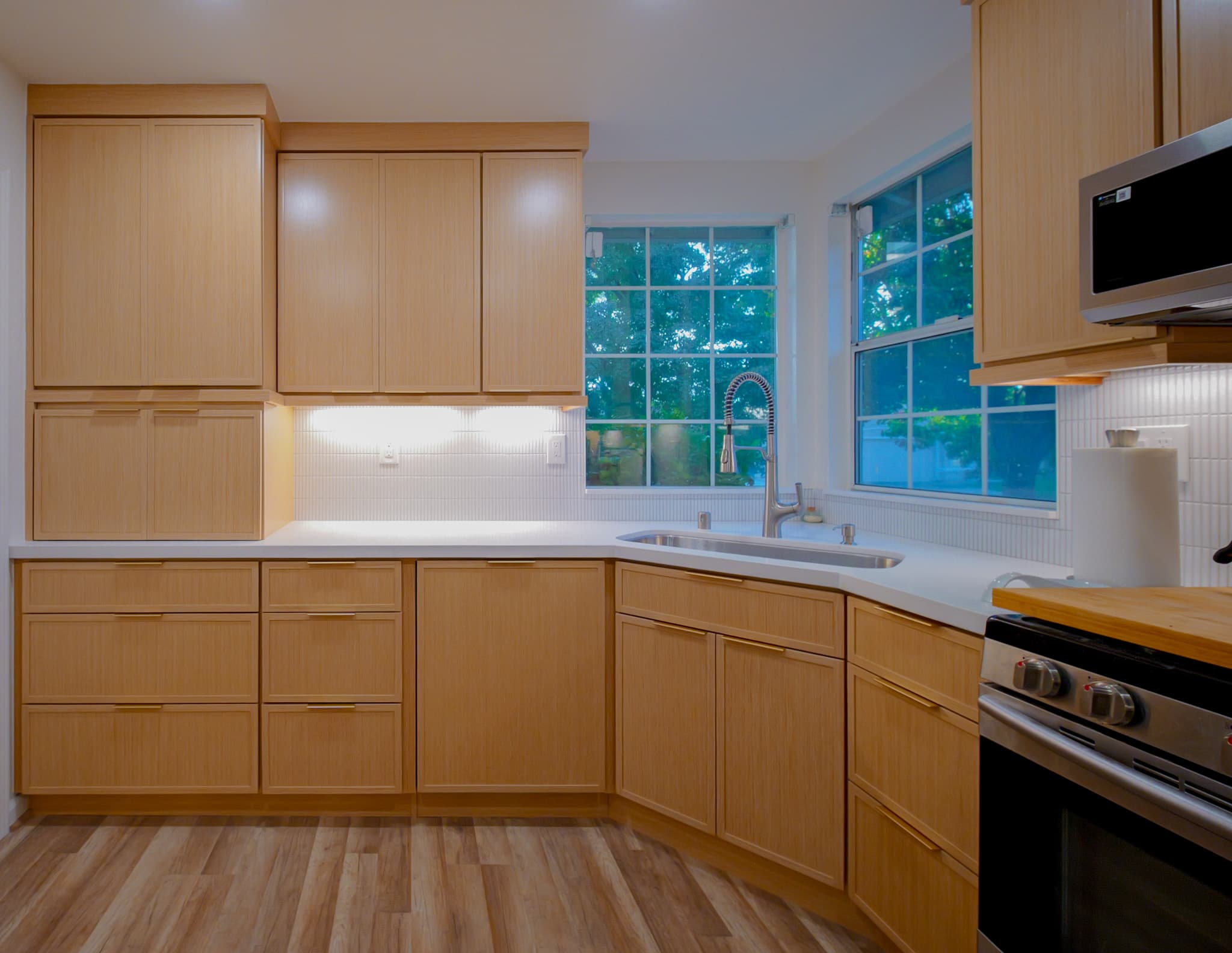 Kitchen Remodel in Antelope — custom cabinetry, quartz countertop, under-cabinet lighting, undermount sink, luxury vinyl plank