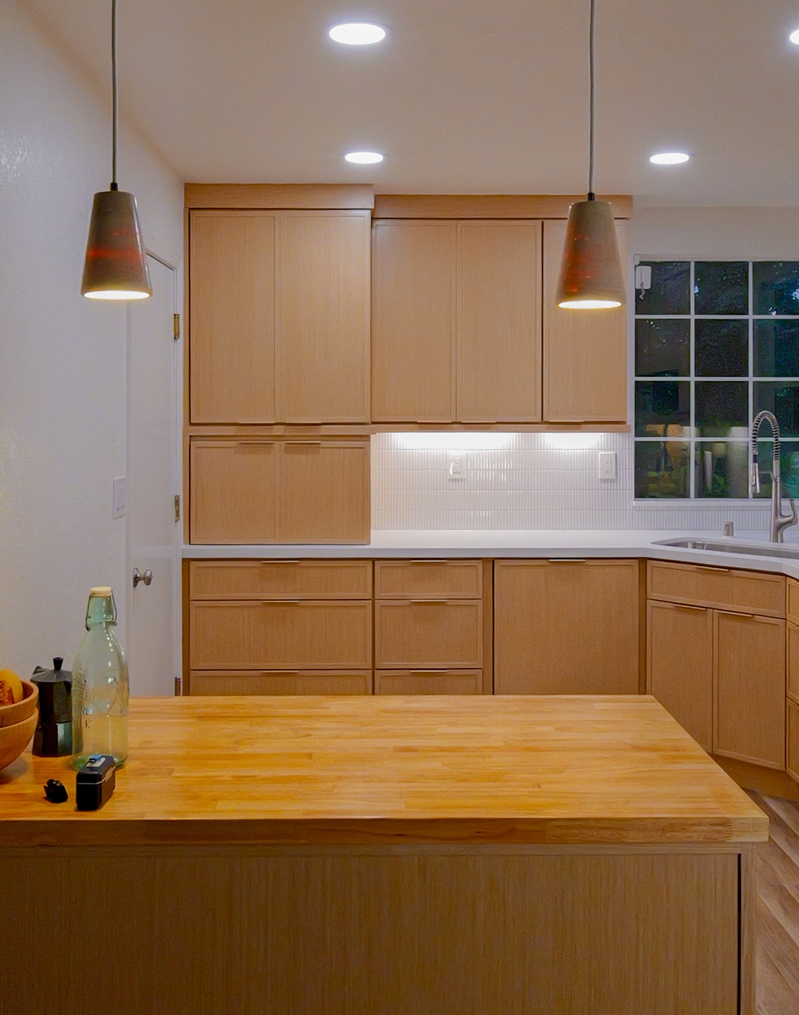 Kitchen Remodel in Antelope — custom cabinetry, butcher-block countertop, pendant lighting, recessed lighting, under-cabinet lighting
