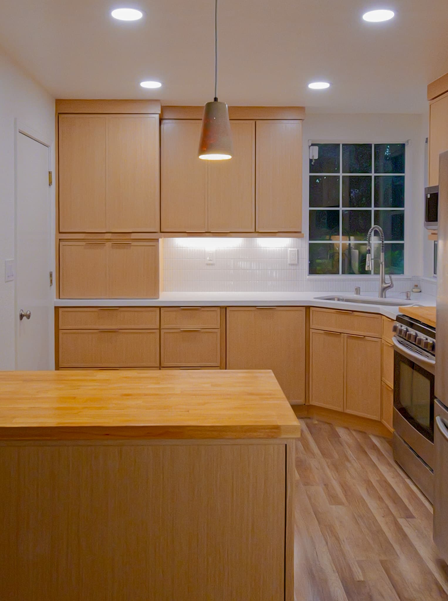 Kitchen Remodel in Antelope — custom cabinetry, butcher-block countertop, subway tile backsplash, pendant lighting, recessed lighting