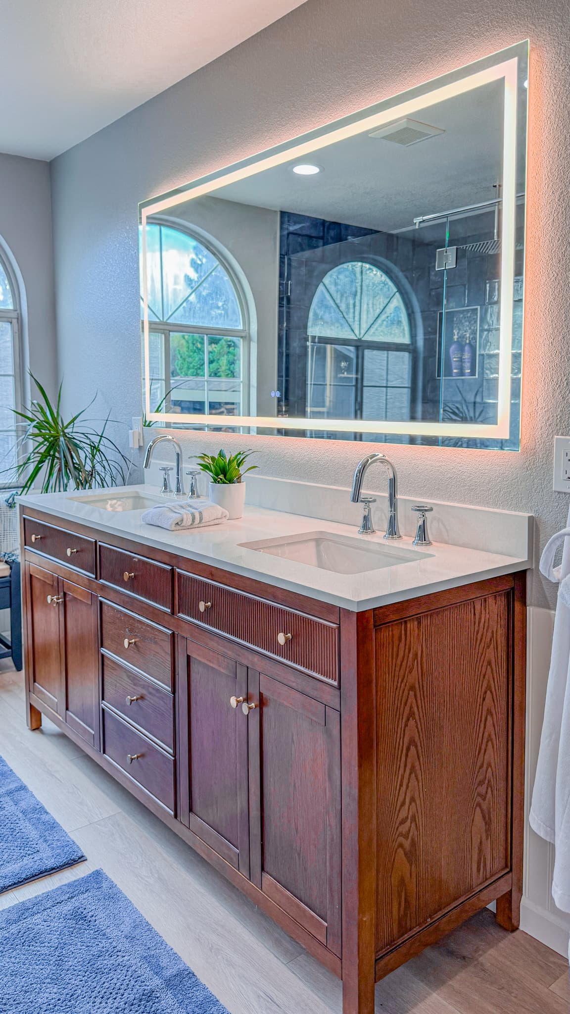 Bathroom Remodel in Sacramento — double vanity, lighted mirror, undermount sink, quartz countertop, luxury vinyl plank