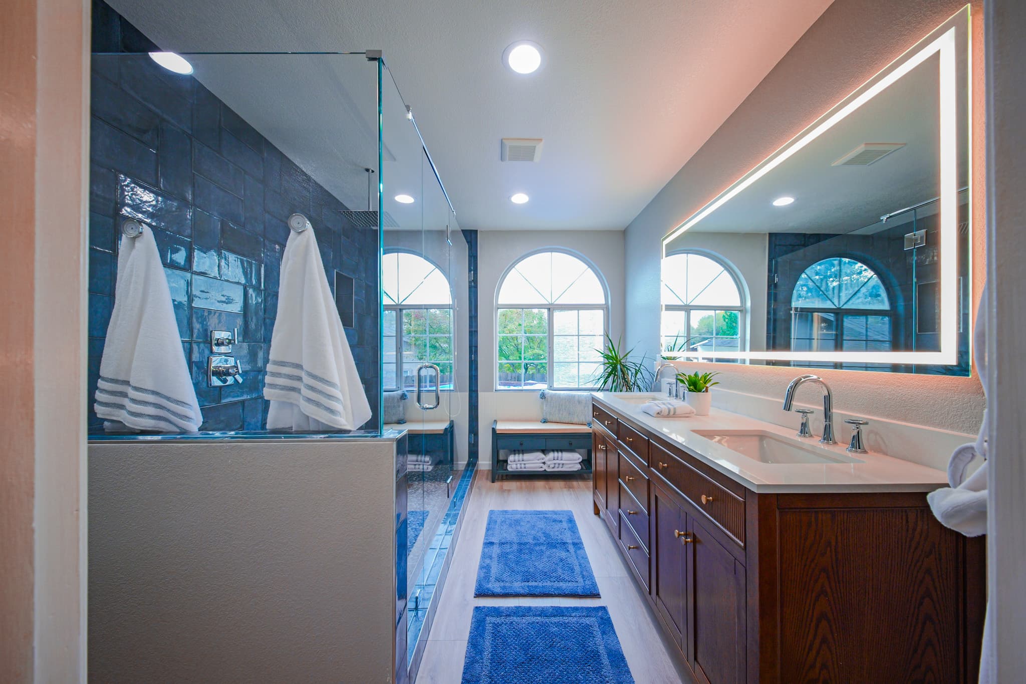 Bathroom Remodel in Sacramento — frameless glass shower, tiled shower surround, double vanity, lighted mirror, recessed lighting