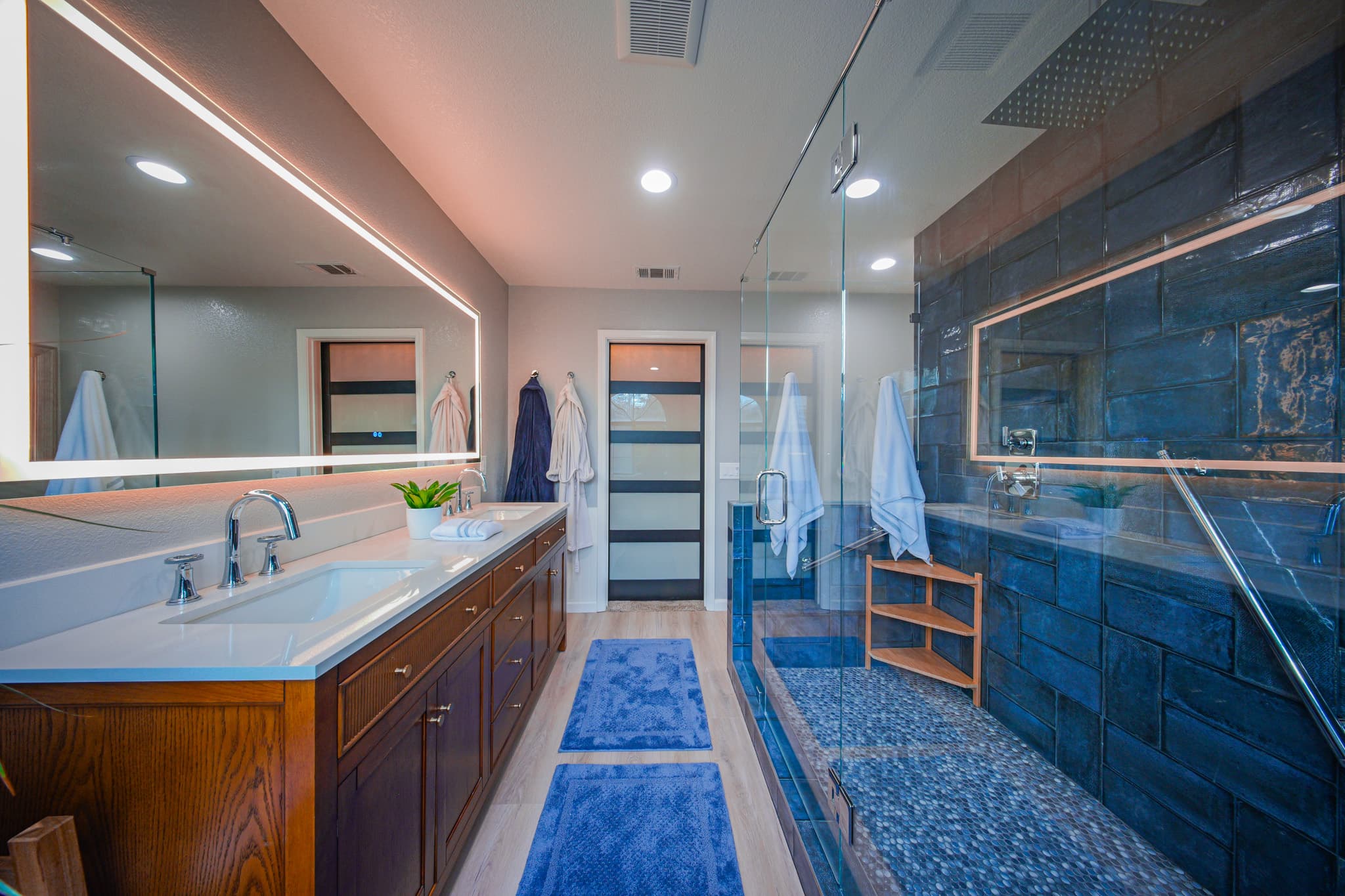 Bathroom Remodel in Sacramento — frameless glass shower, tiled shower surround, lighted mirror, double vanity, shower bench