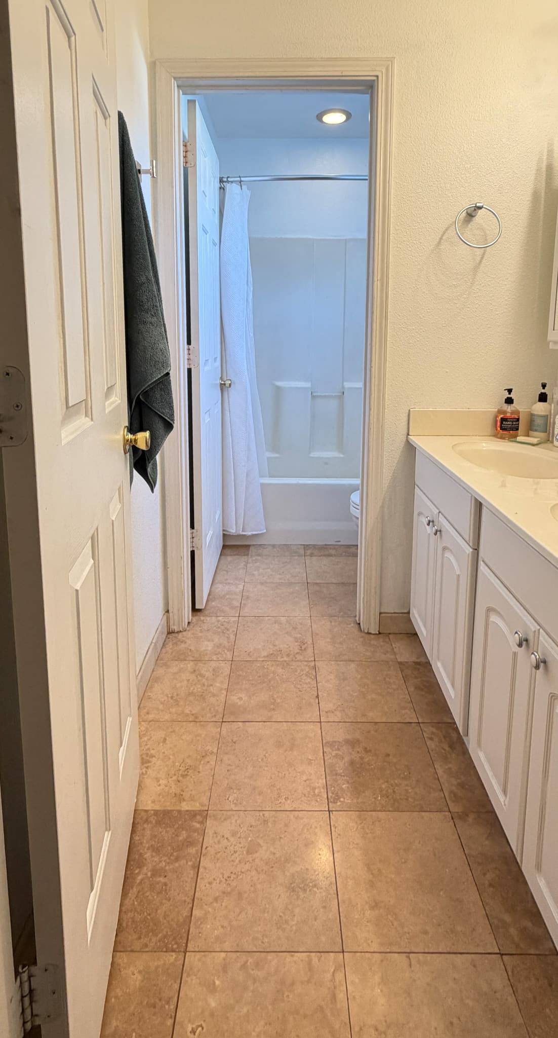 Bathroom Remodel in Sacramento — before remodel — original finishes, raised-panel cabinets, ceramic tile flooring, single vanity, recessed lighting