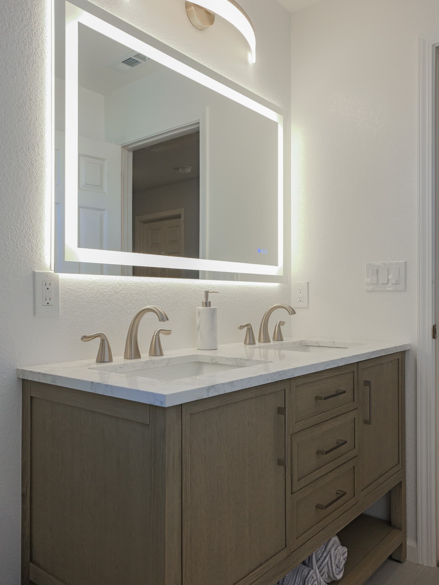 Bathroom Remodel in Sacramento — double vanity, lighted mirror, undermount sink, quartz countertop, shaker cabinets
