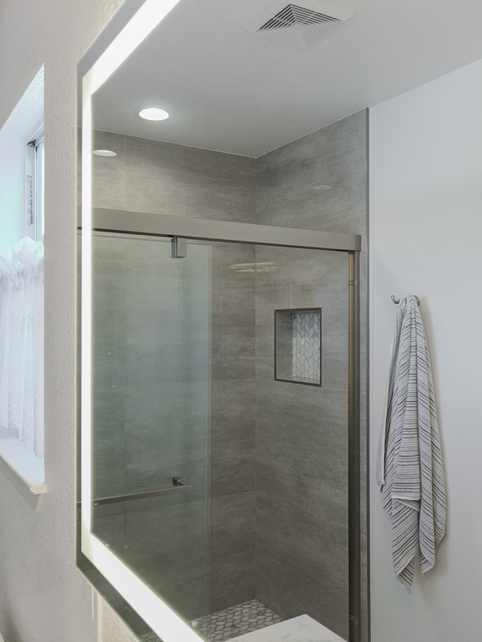 Bathroom Remodel in Sacramento — walk-in shower, frameless glass shower, tiled shower surround, mosaic backsplash, recessed lighting